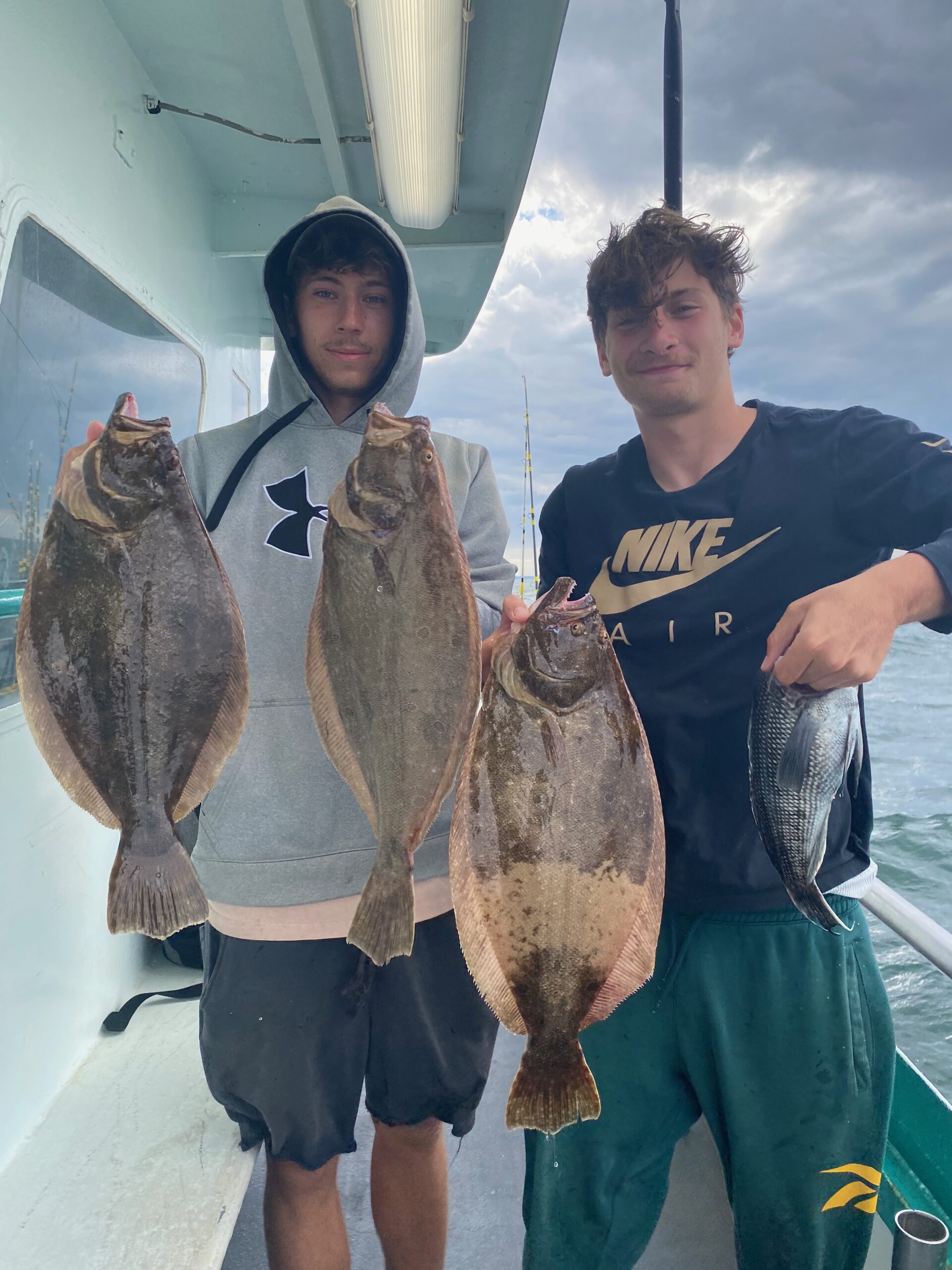 a man and a woman holding a fish