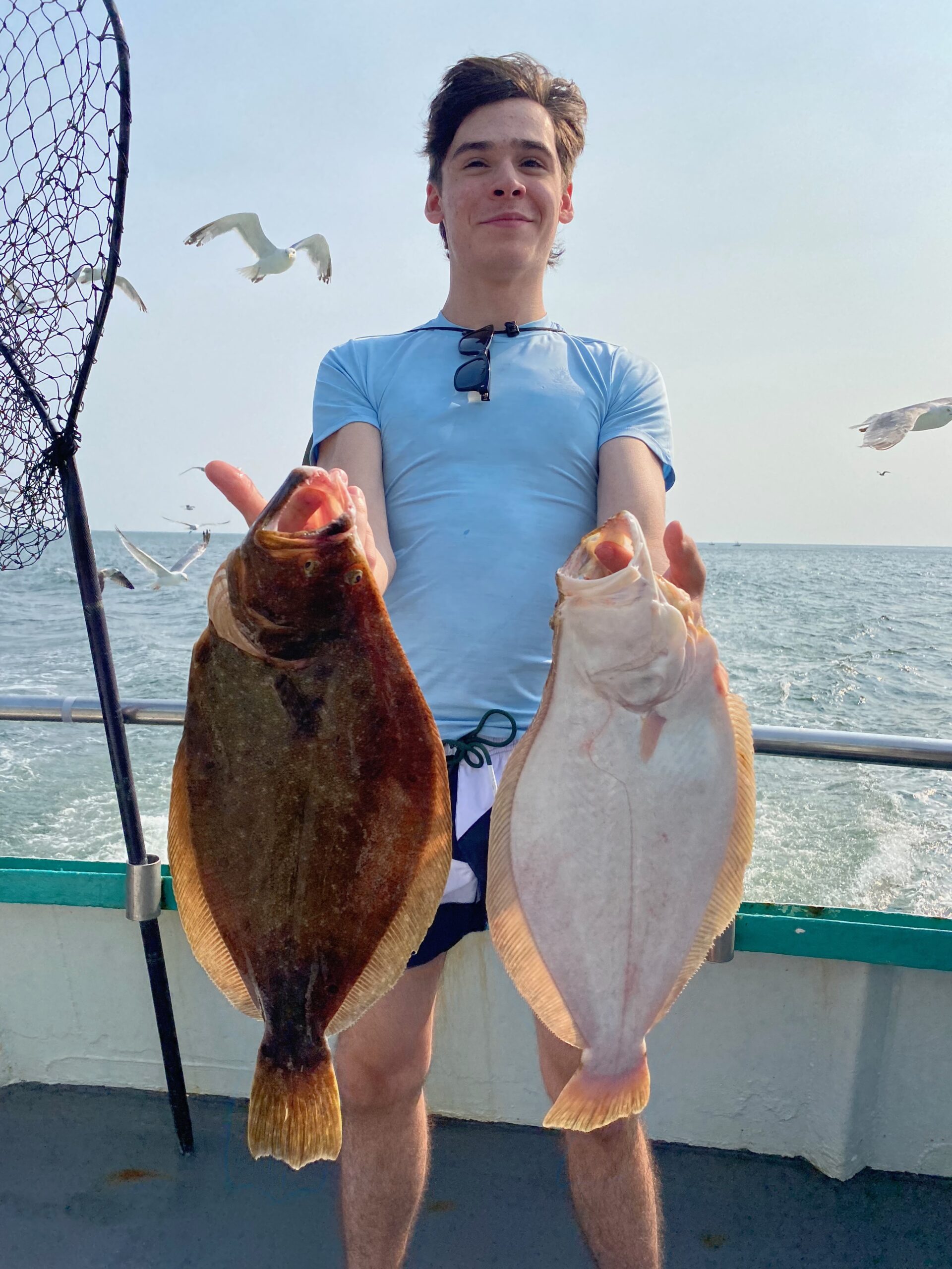 a man holding a fish in the water