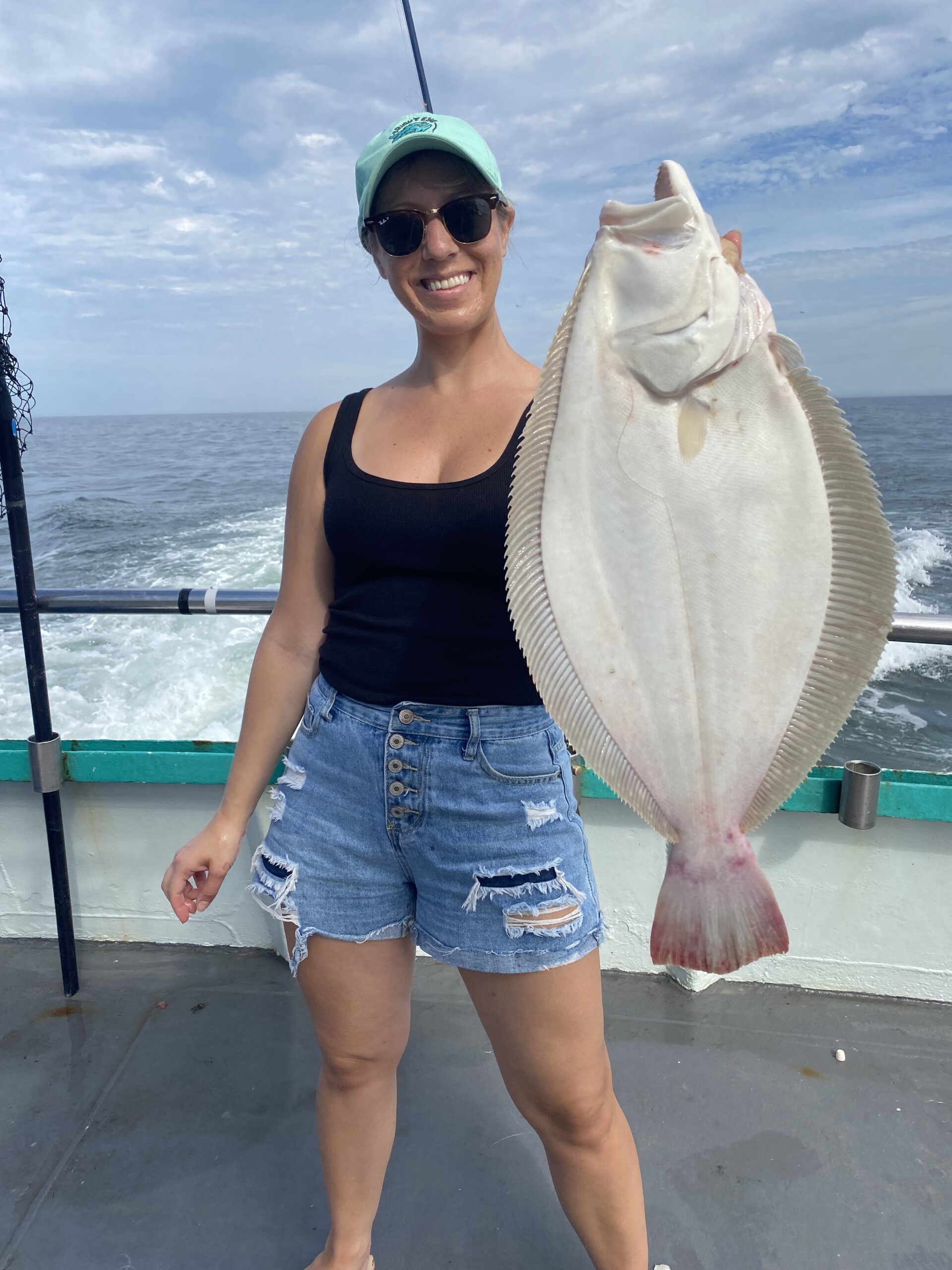 a woman standing in front of a body of water