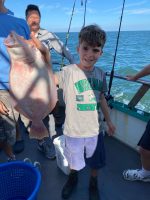 a young man holding a fish