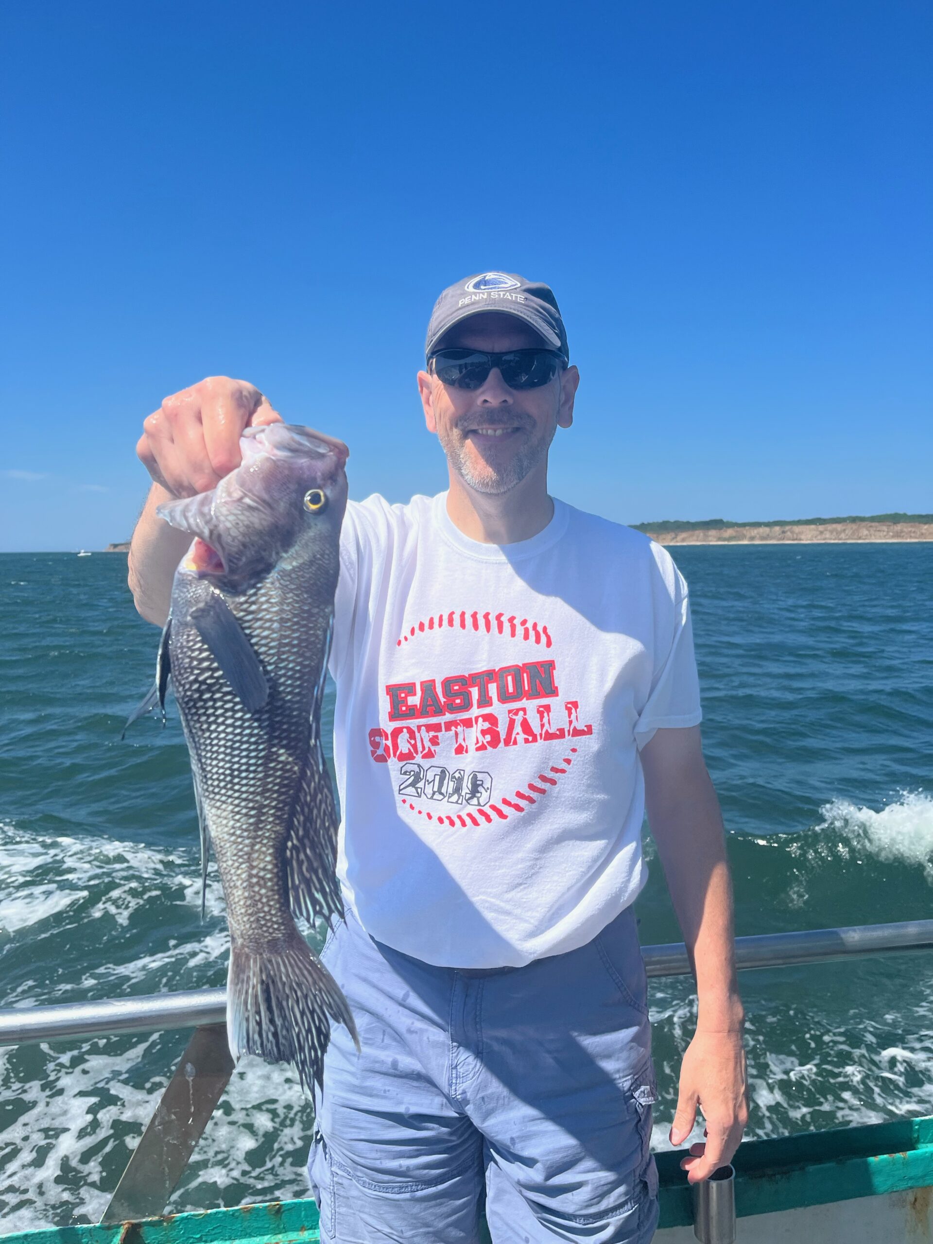 a man holding a fish in the water