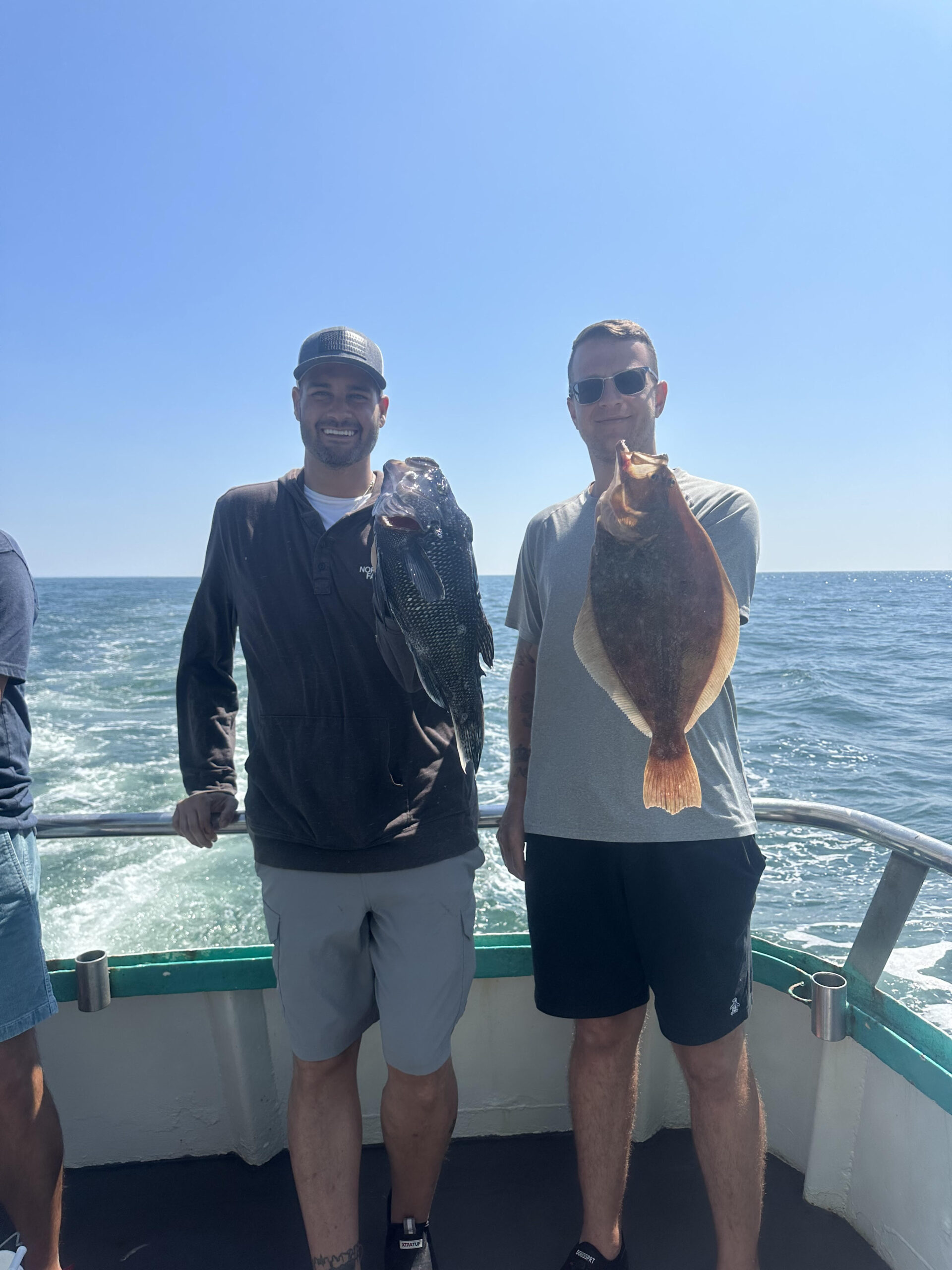 a group of people standing next to a body of water