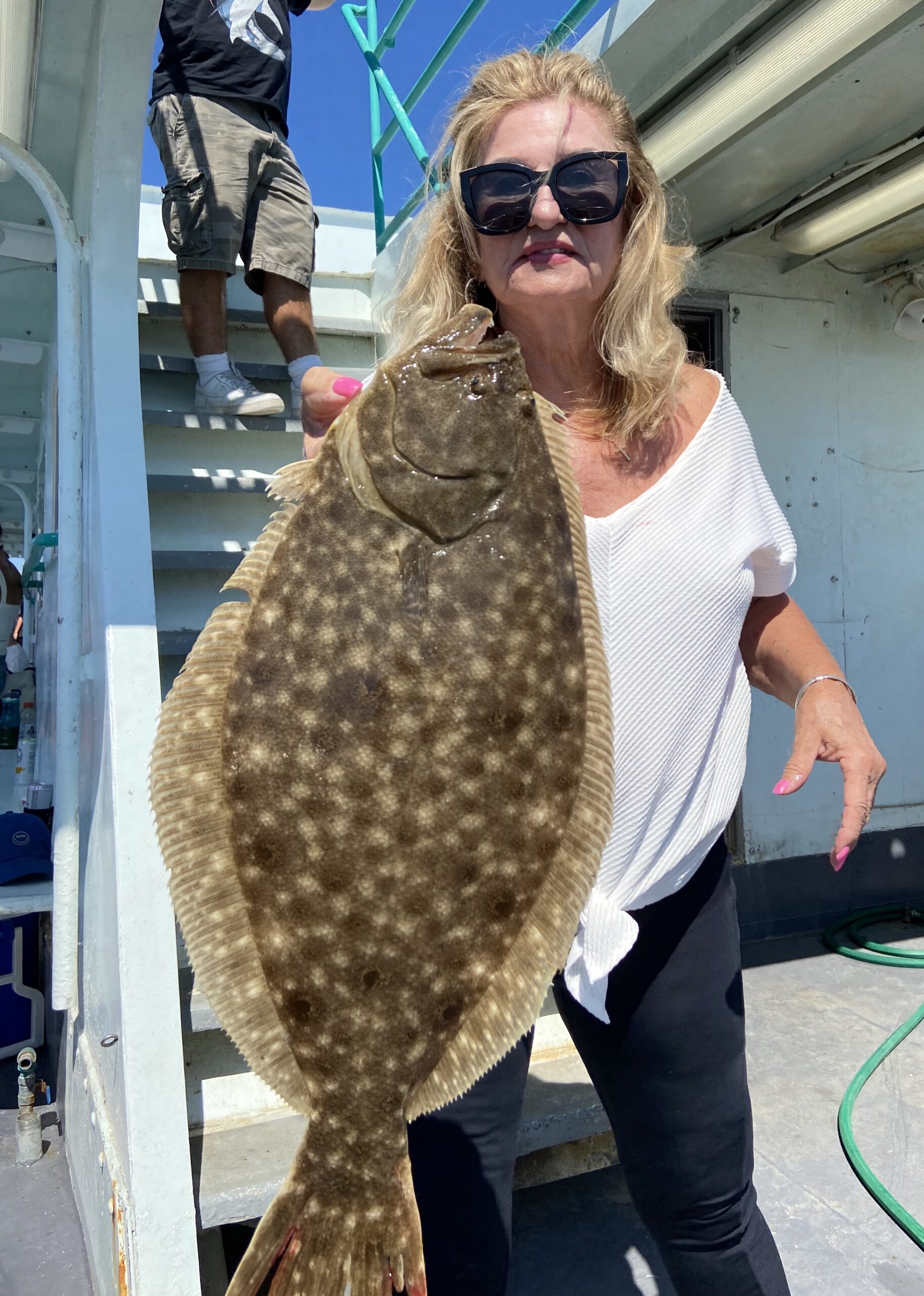 a person wearing sunglasses and standing in front of a building