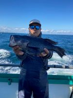 a person holding a fish in the water