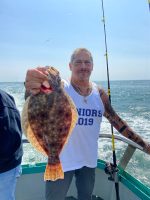 a man holding a fish in the water