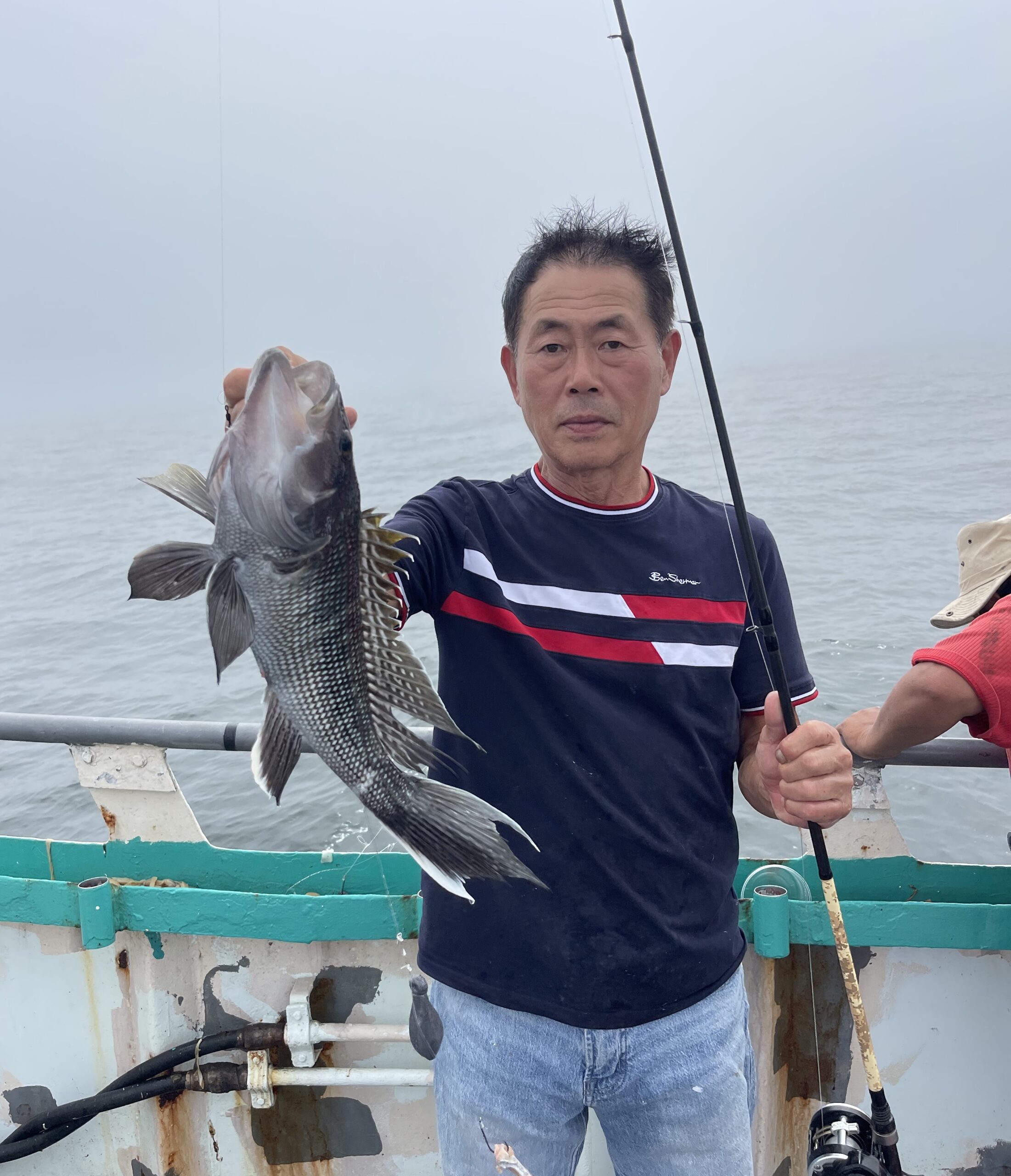 a man holding a fish in the water