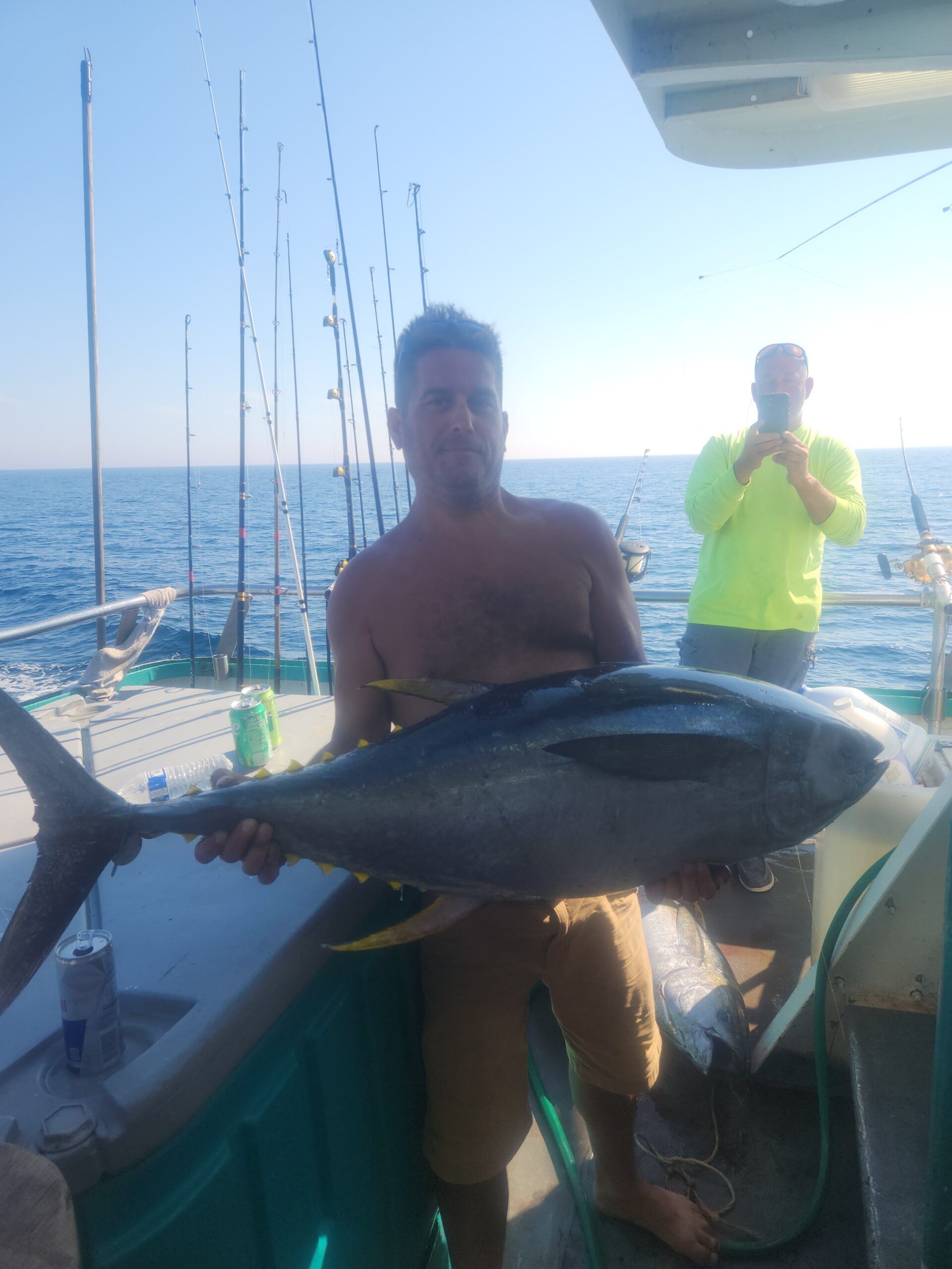 a man holding a fish on a boat