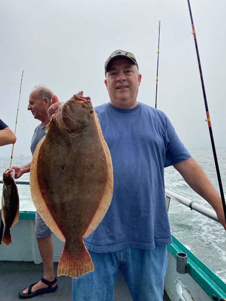 a man holding a fish