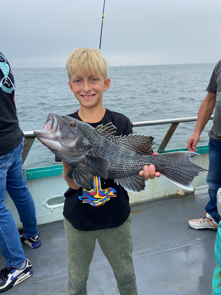 a person holding a fish in the water