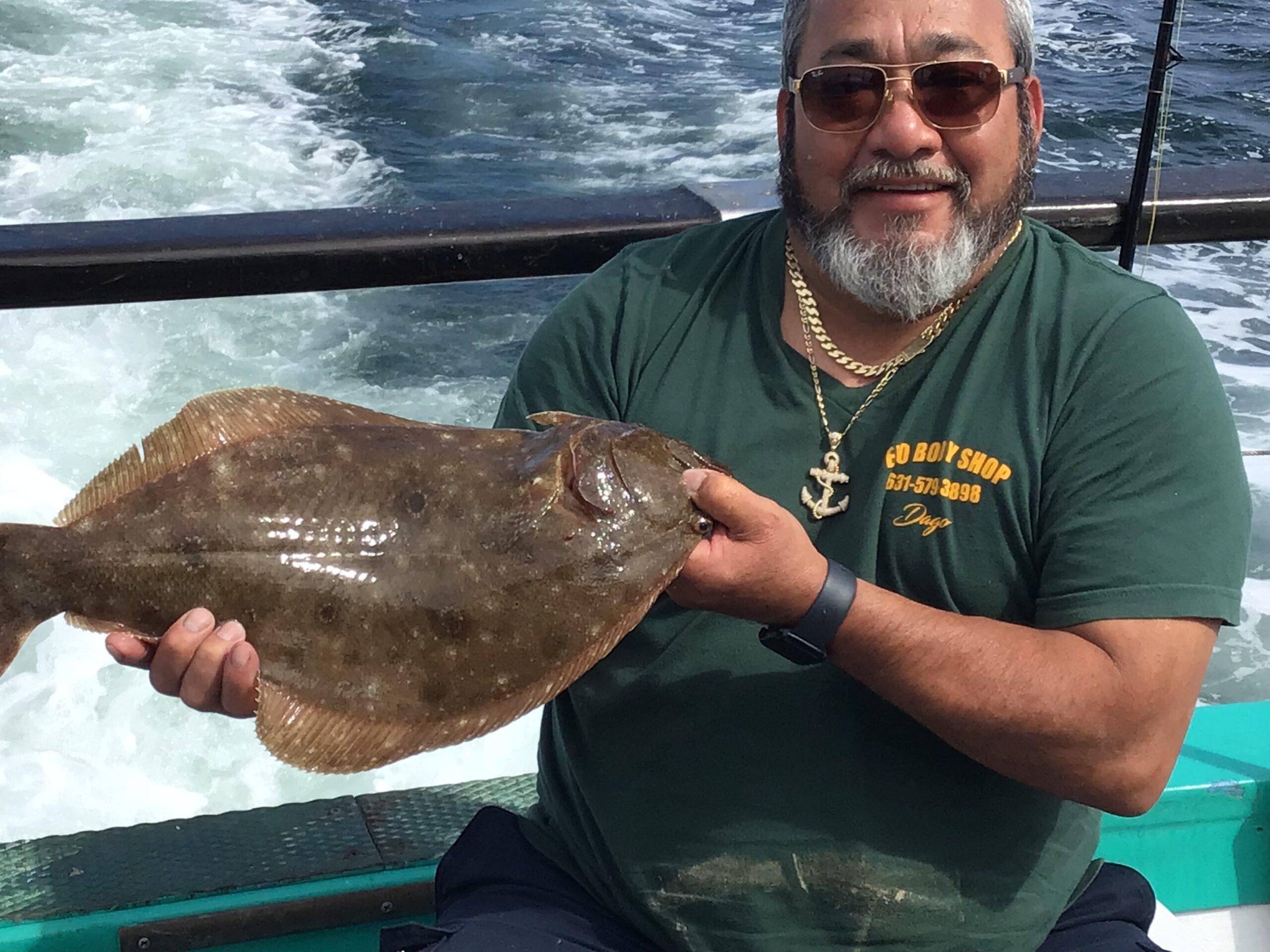 a man holding a fish in the water