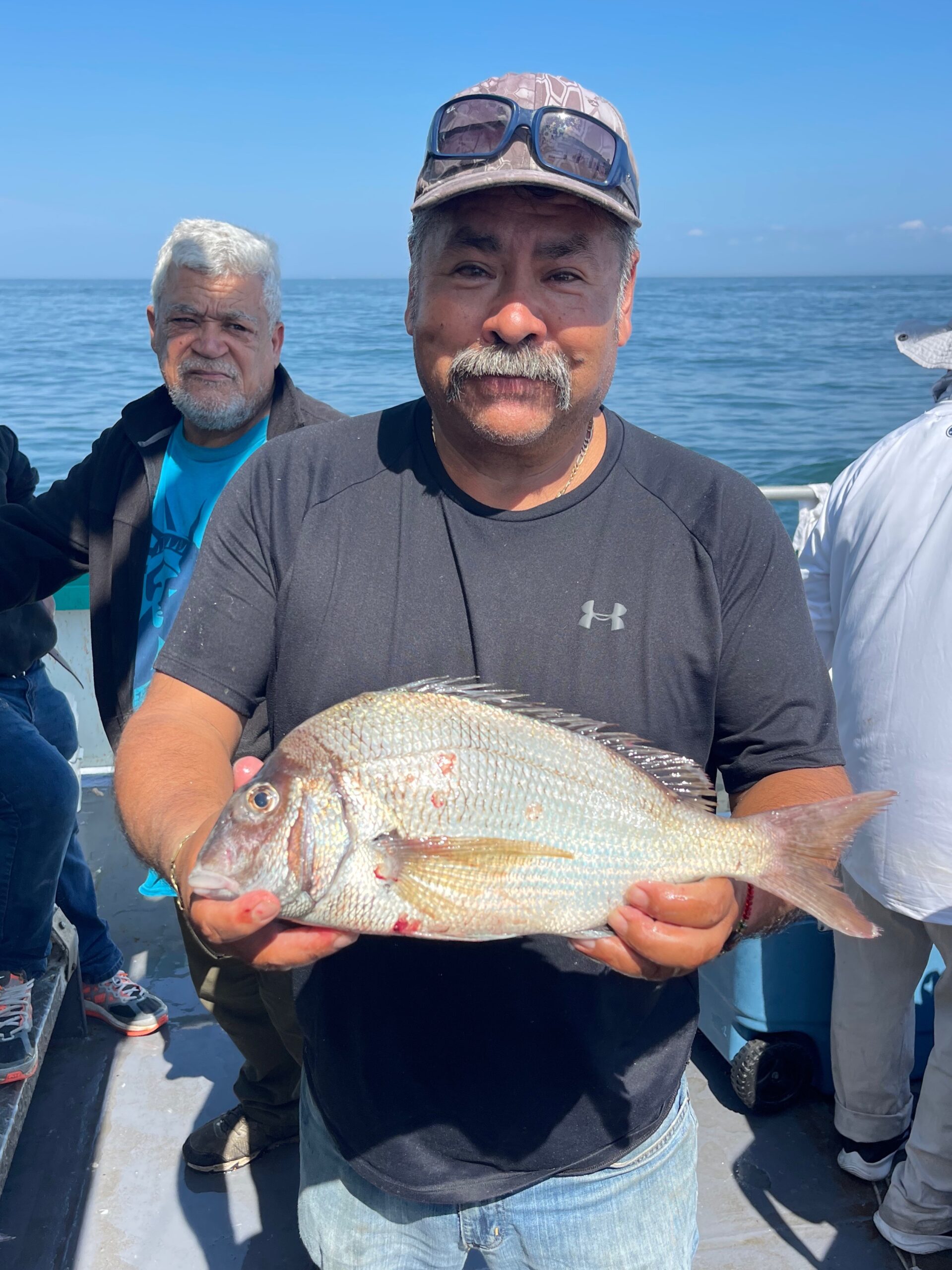 a person holding a fish in the water