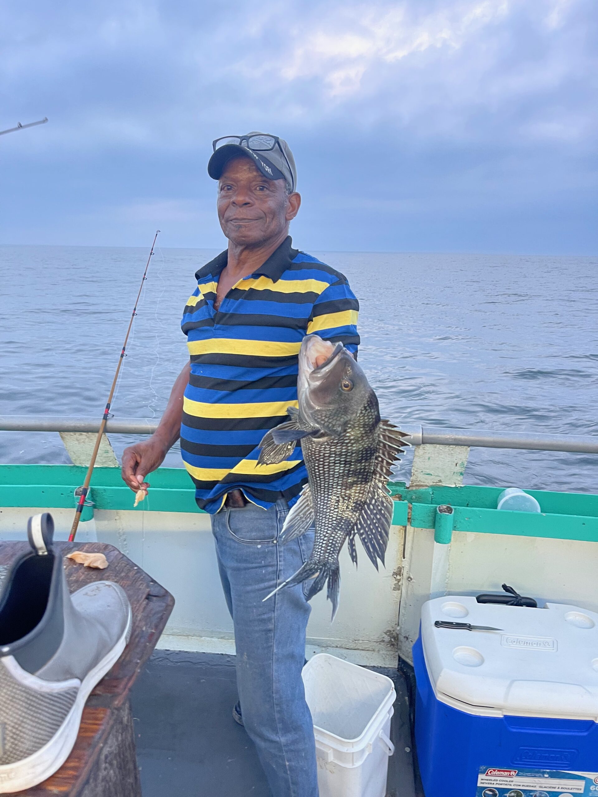 a man standing next to a body of water