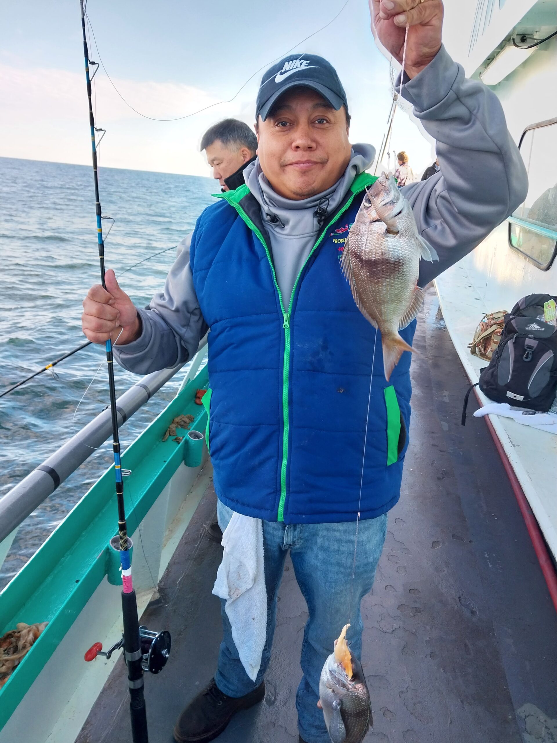 Terrence Howard holding a fish in the water