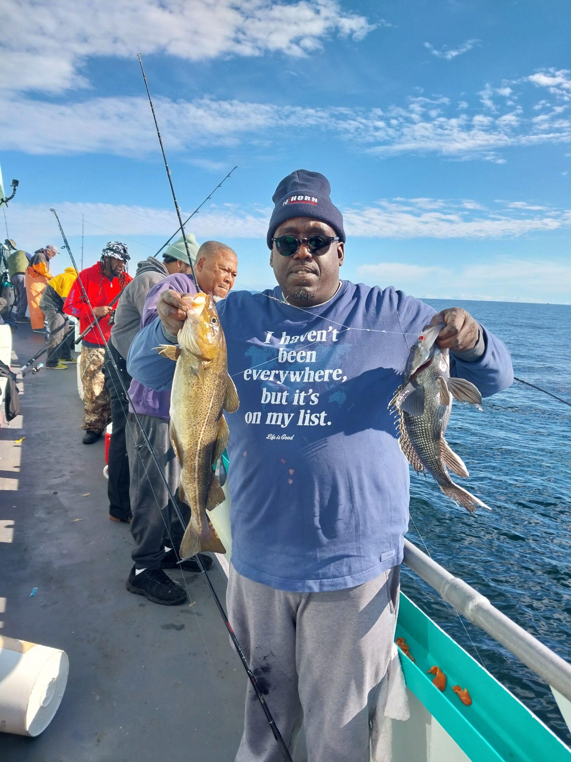 a group of people standing in front of a fish