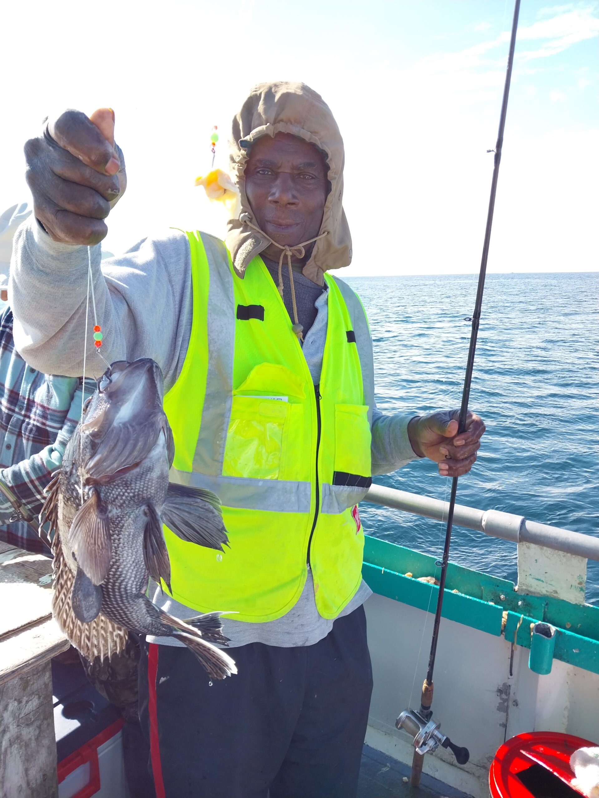 a person holding a fish in the water