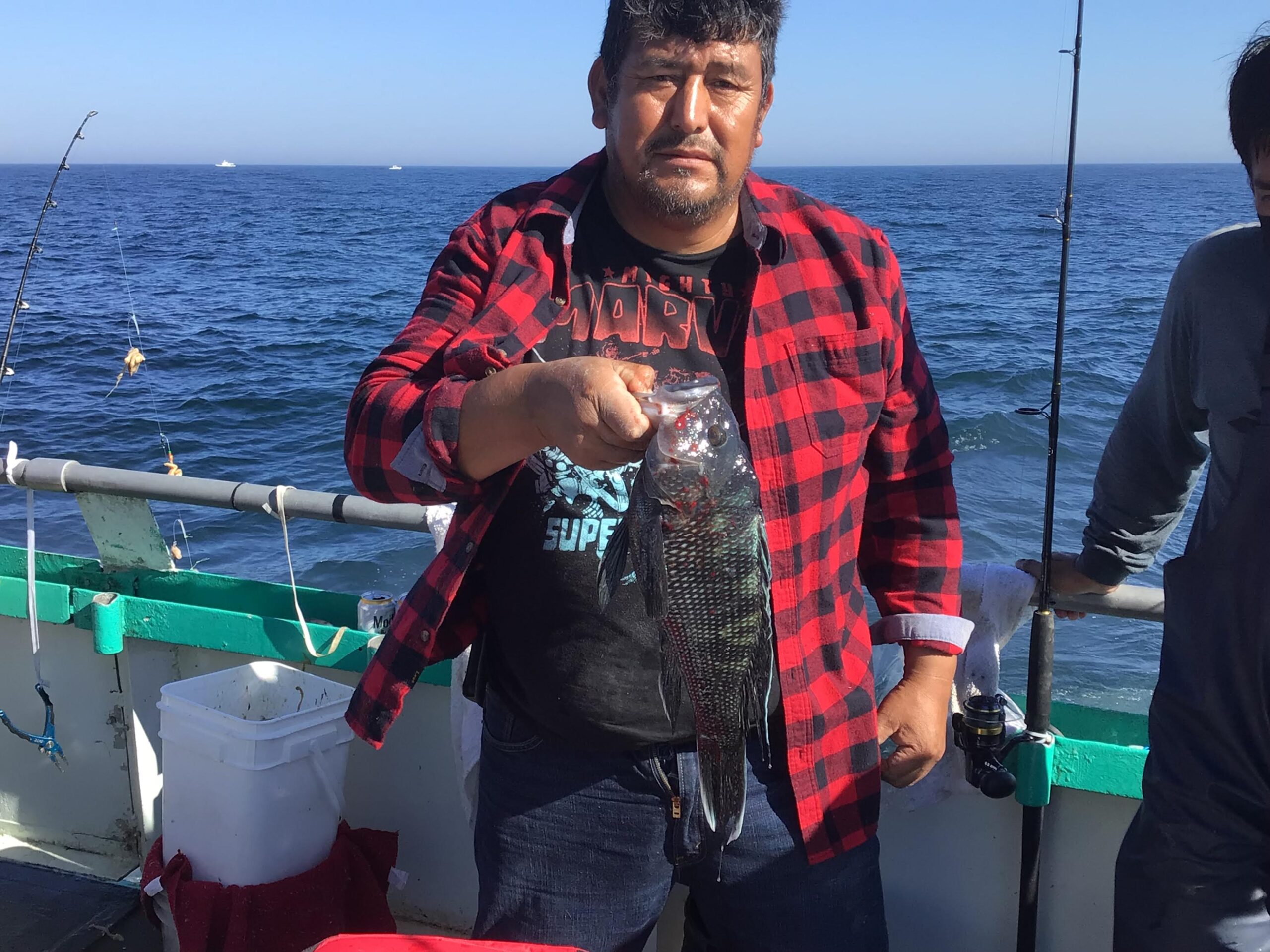 a man standing next to a body of water