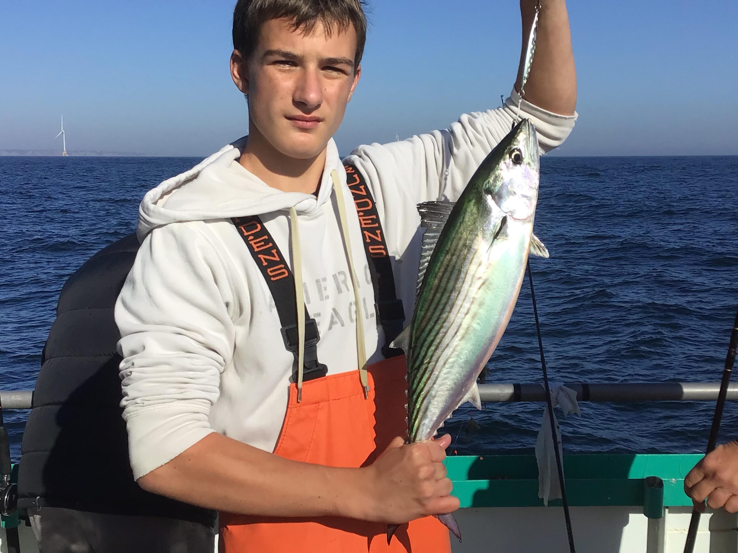 a man holding a fish in the water