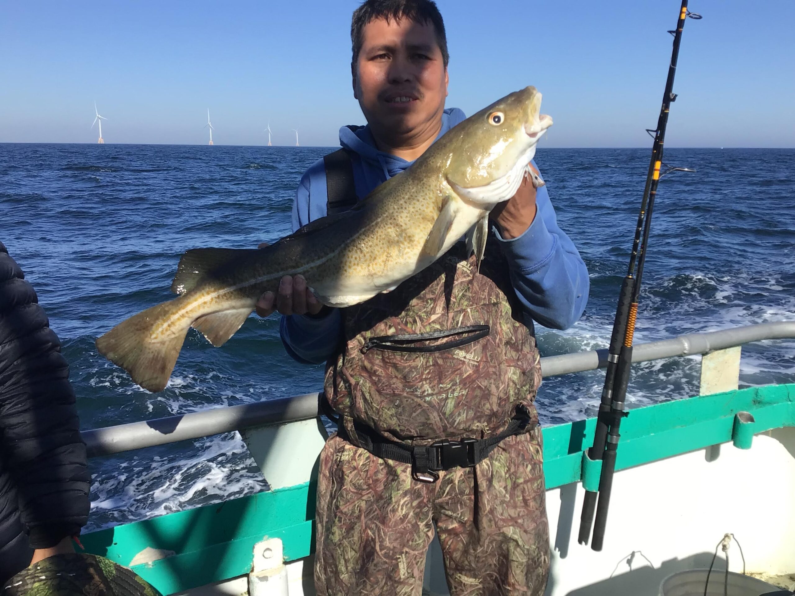 a man holding a fish in the water