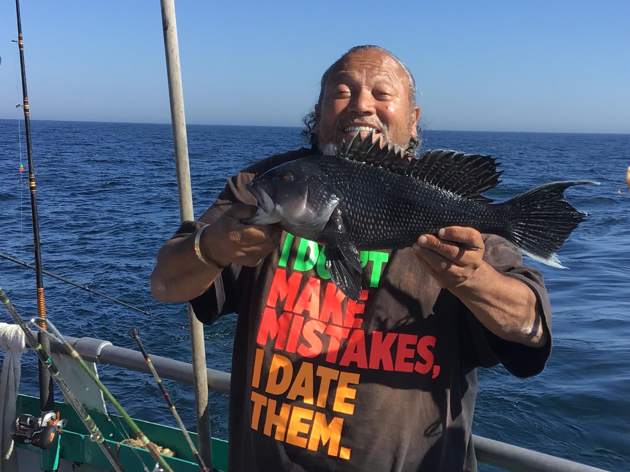 a man standing next to a body of water