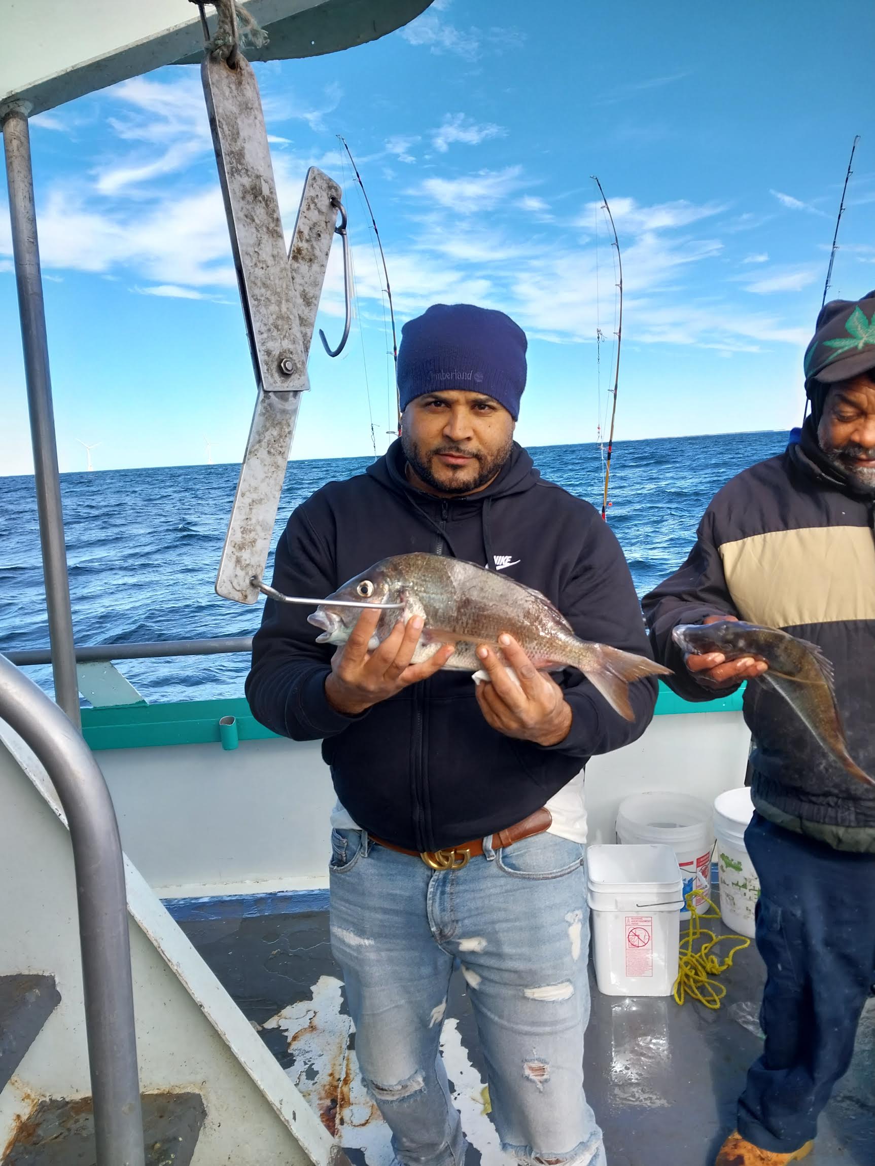 Reese Hoffa holding a fish on a boat in the water