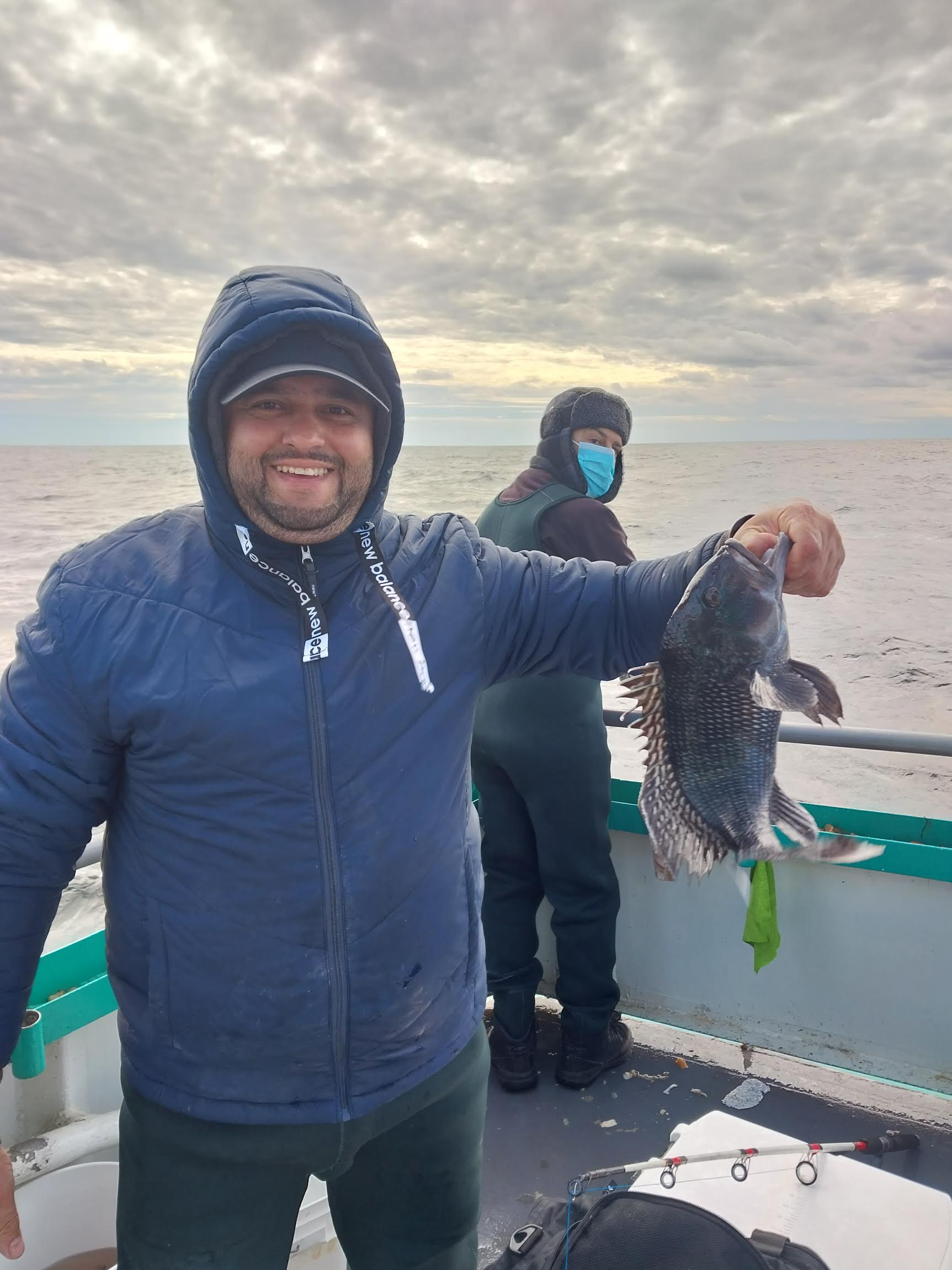 a person holding a fish posing for the camera