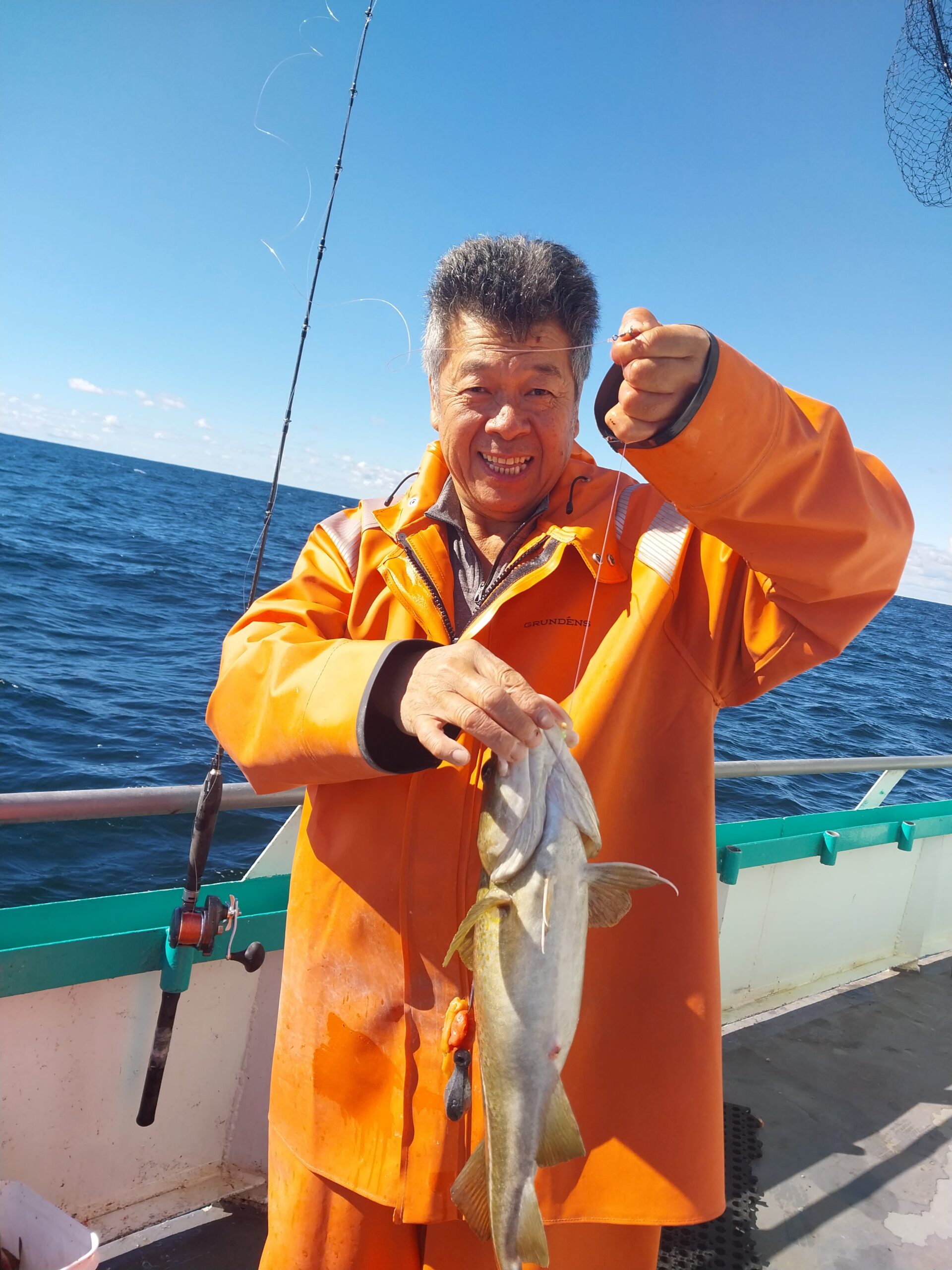 a man holding a fish in the water