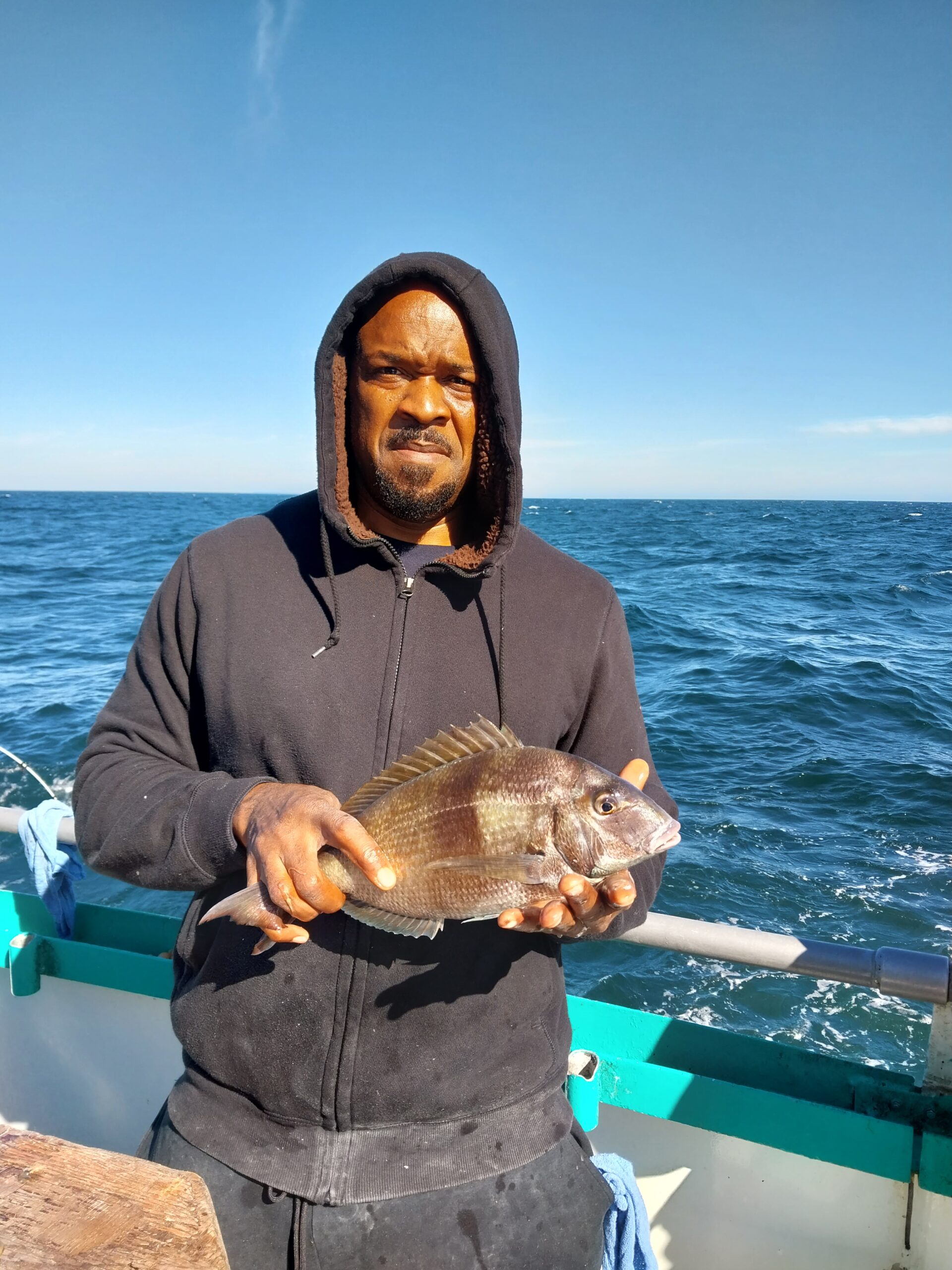 a person standing next to a body of water