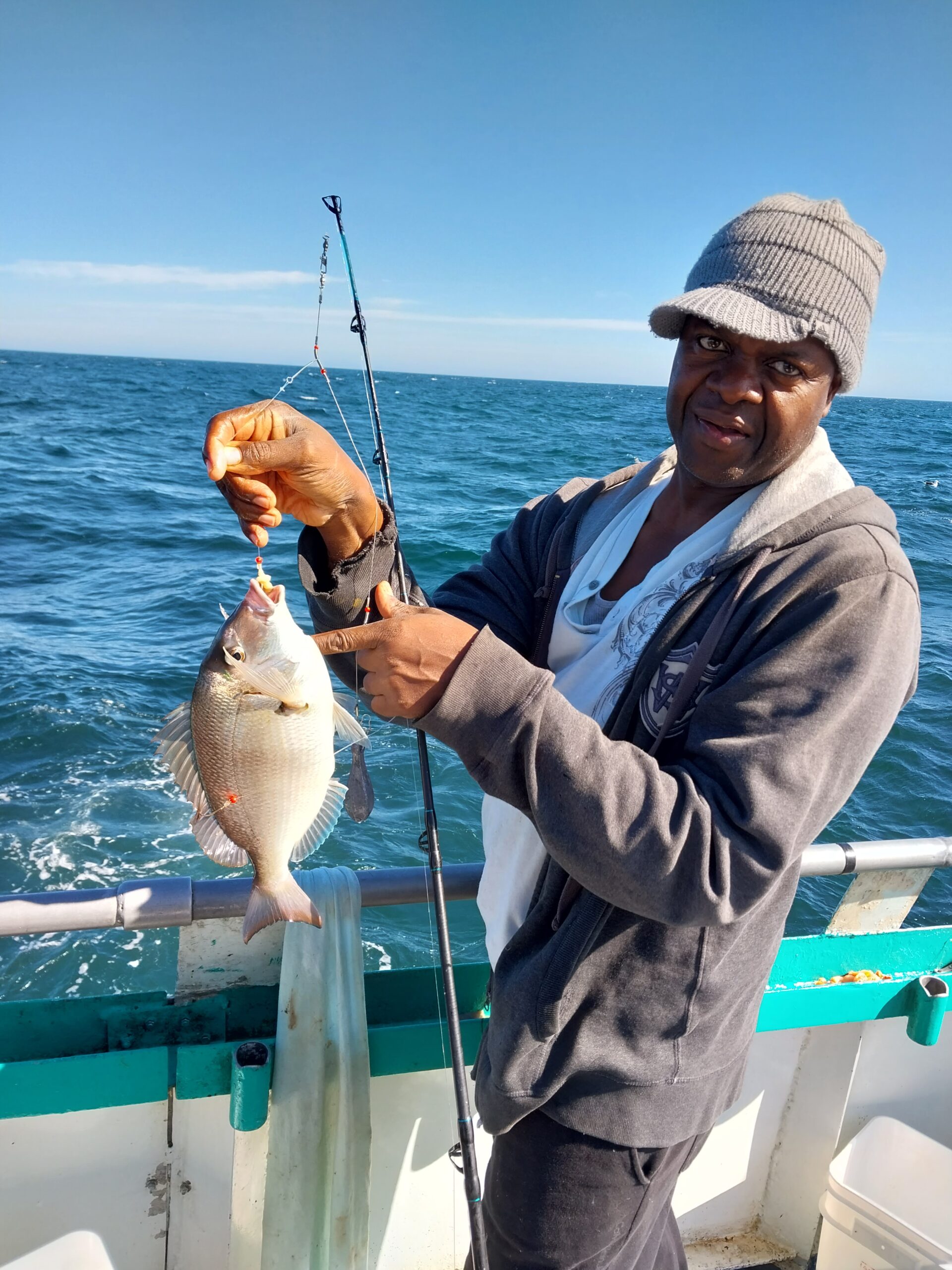 a man holding a fish in the water
