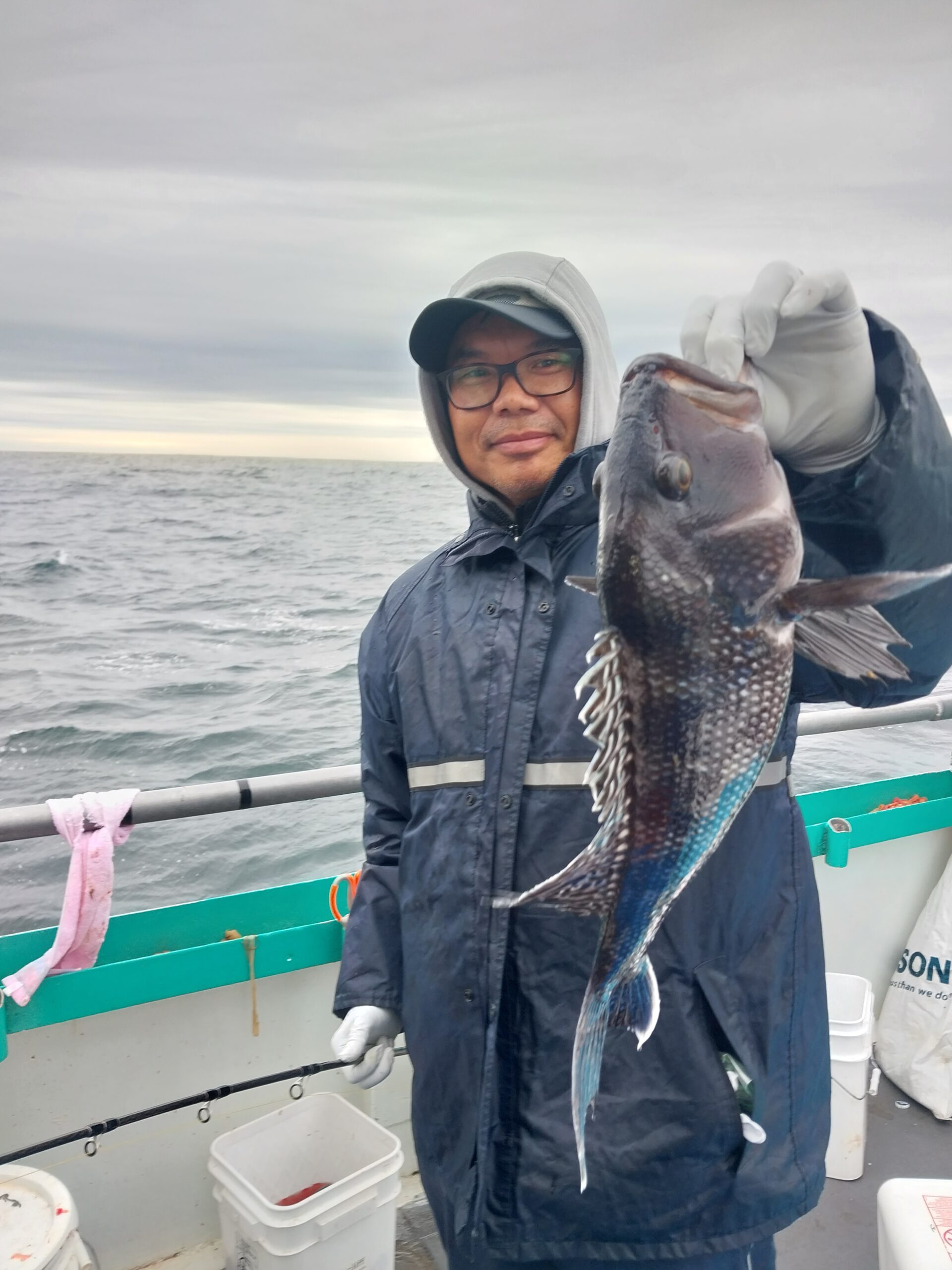 a man holding a fish in the water