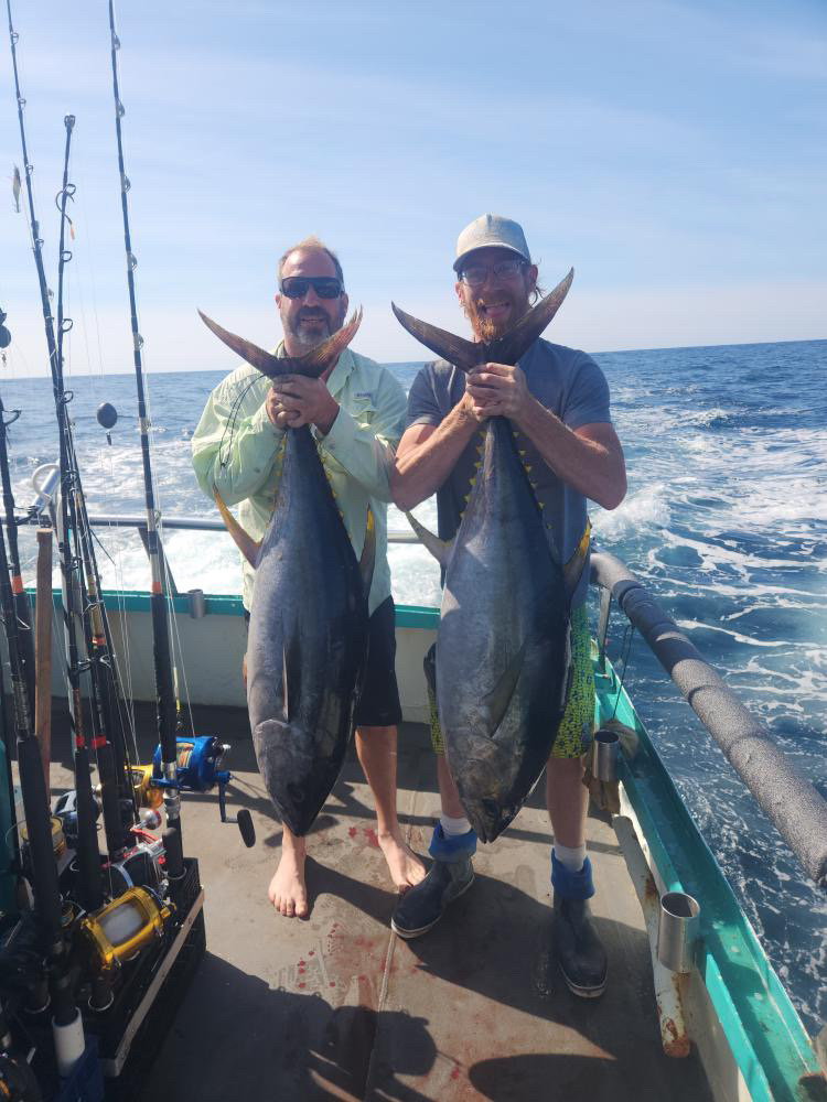 a man holding a fish in the water