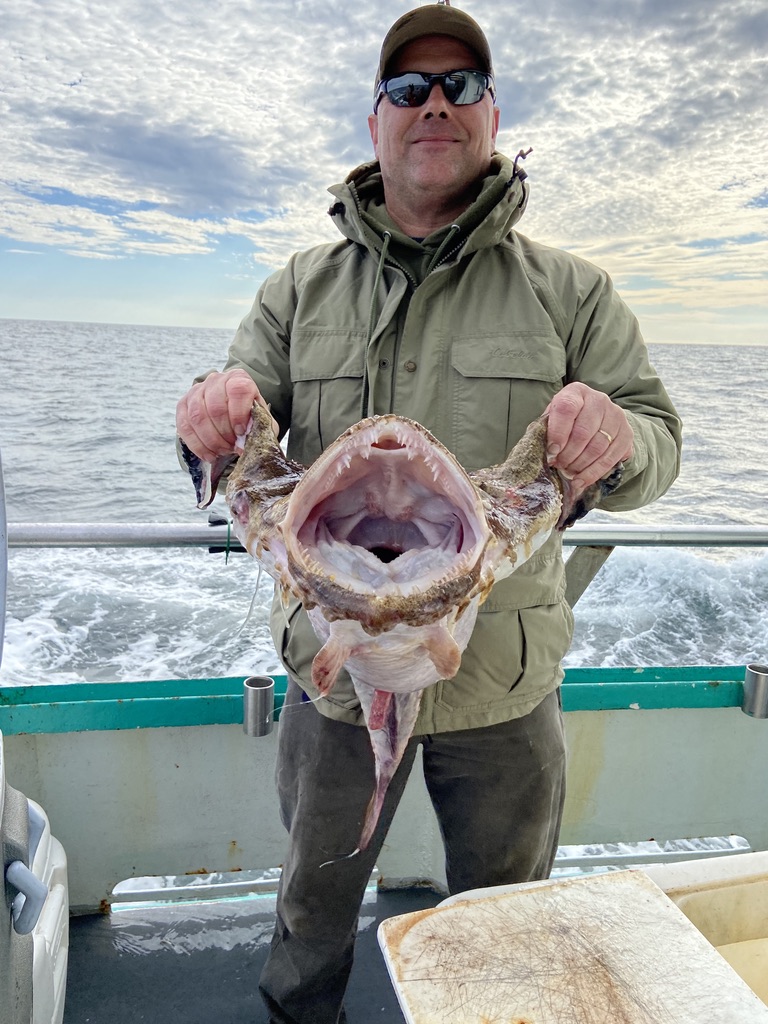 a man holding a fish in the water