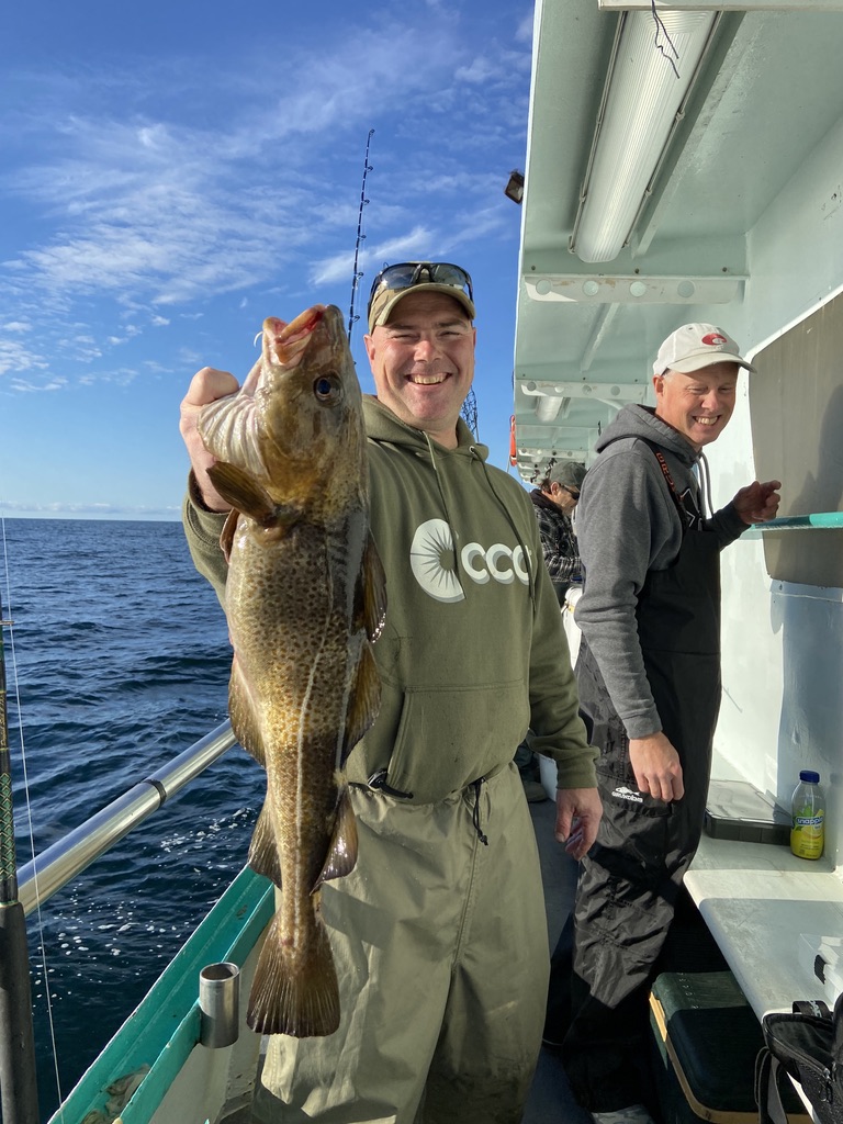 a person holding a fish in the water