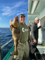 a person holding a fish in the water