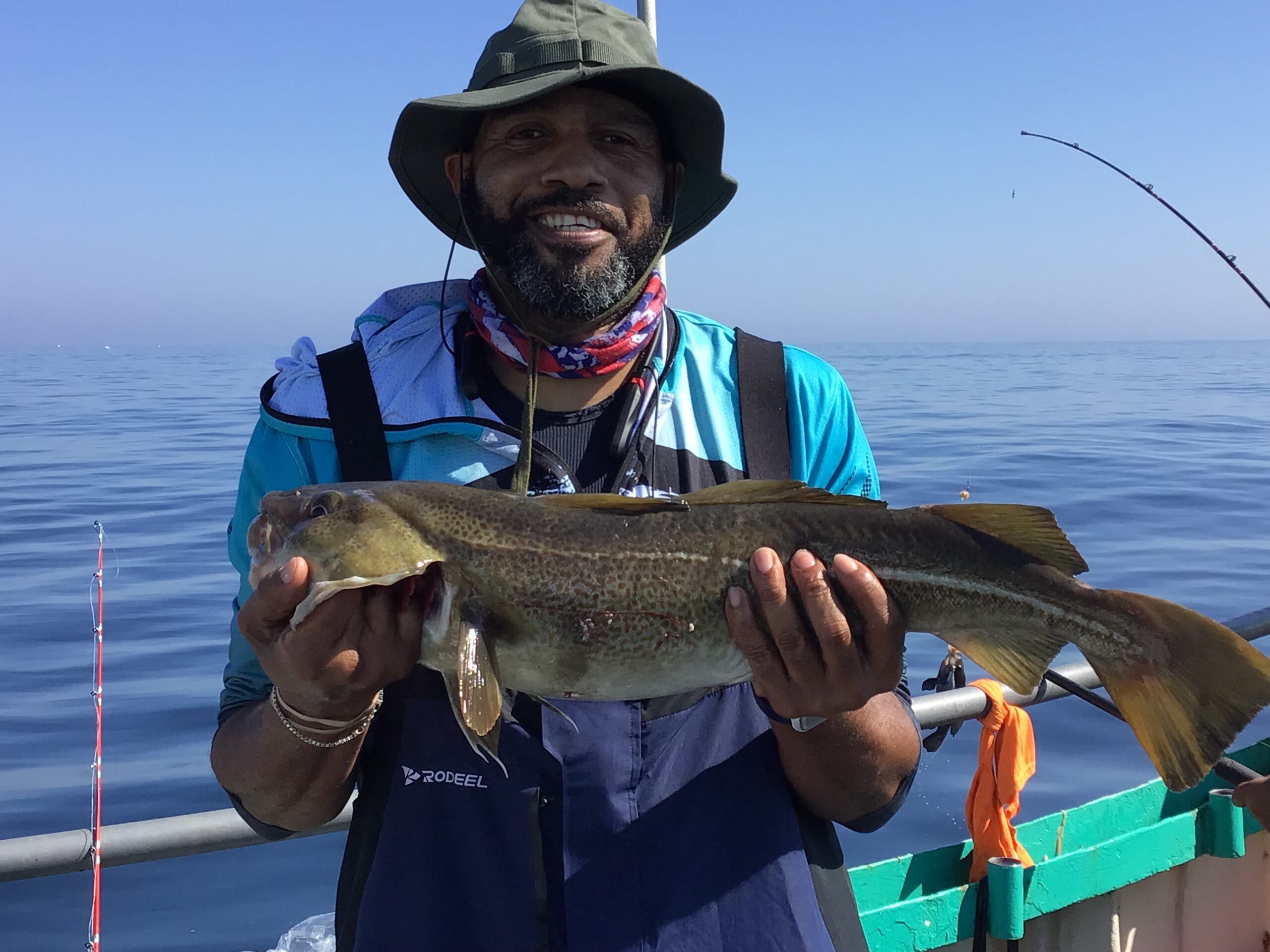 a person holding a fish on a boat in the water
