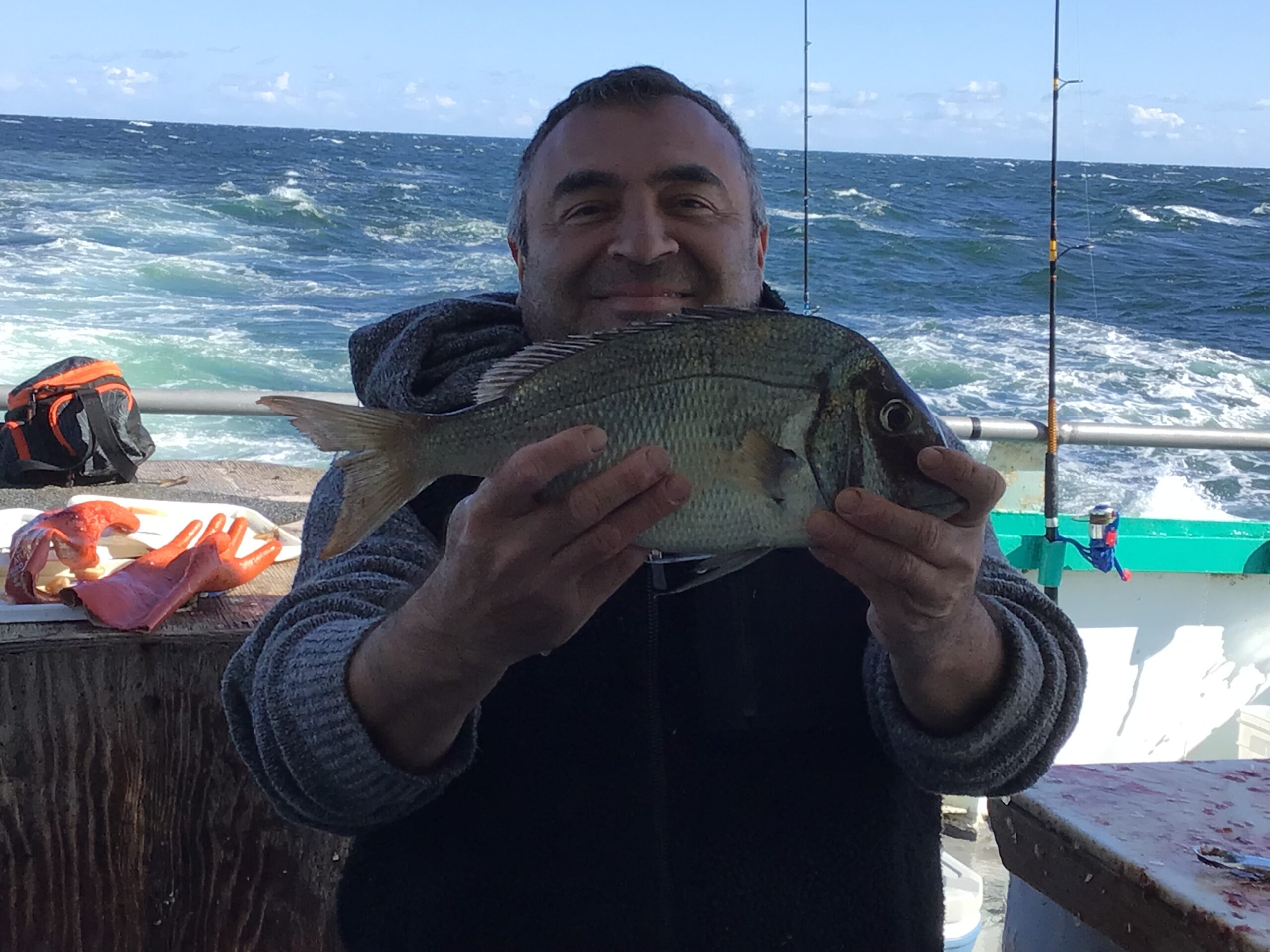 a man holding a fish in the water