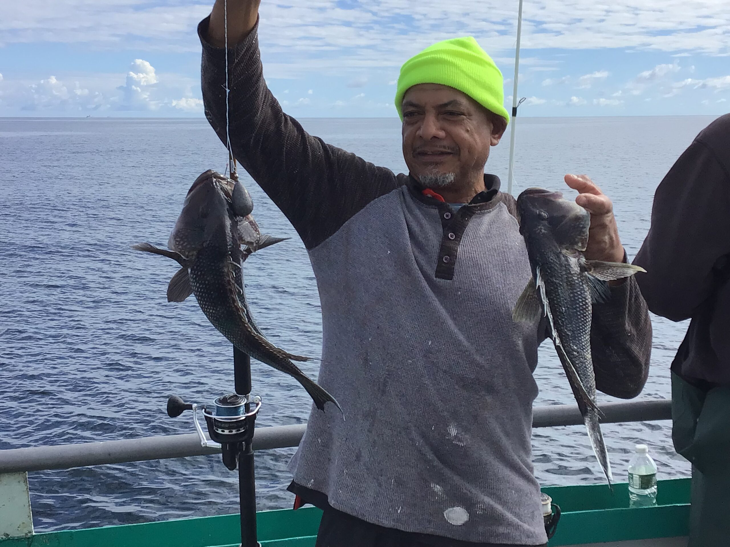 a person holding a fish in the water