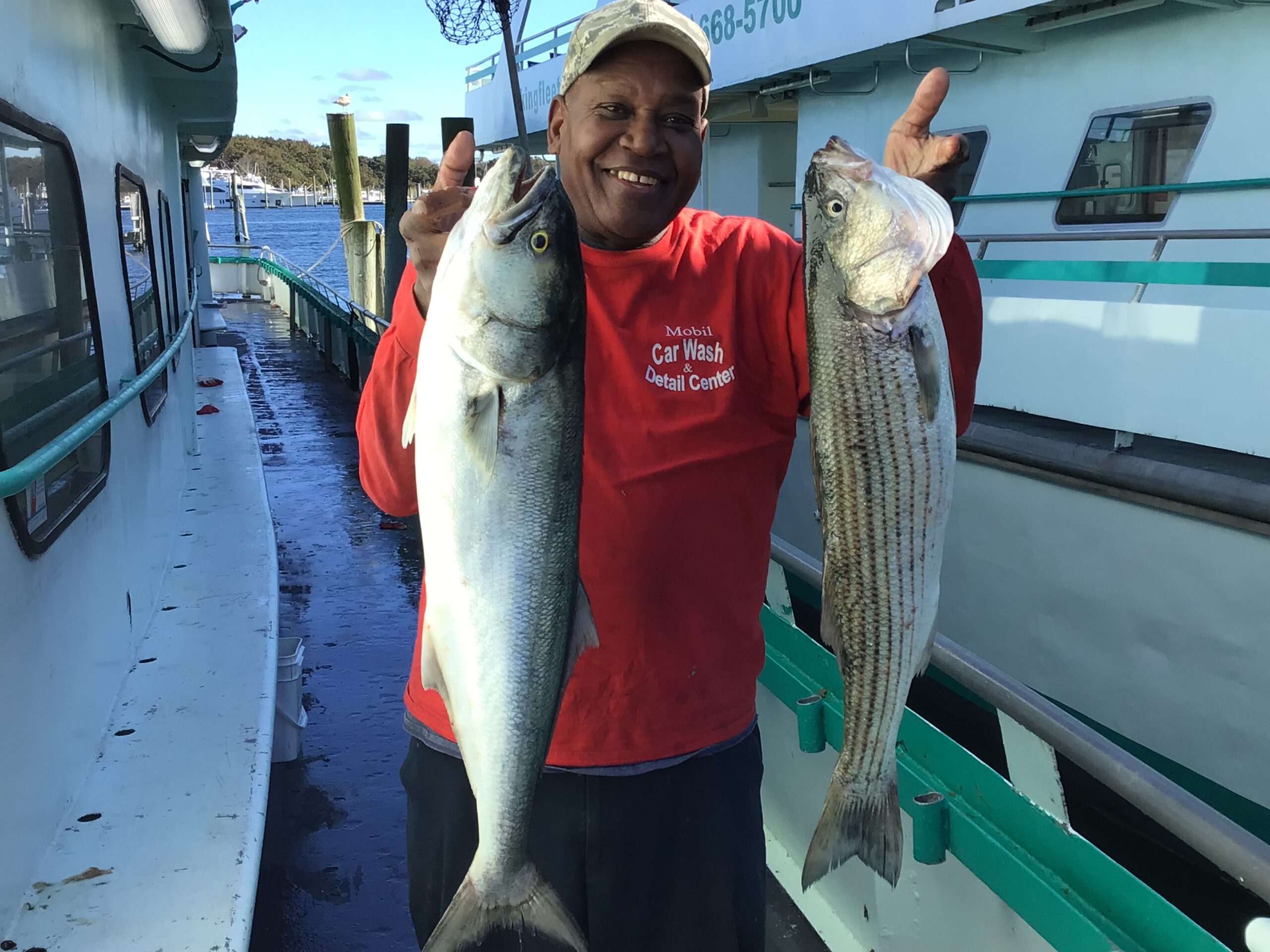 a man holding a fish on a boat