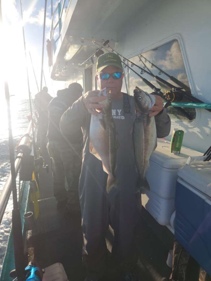 a man standing in front of a car