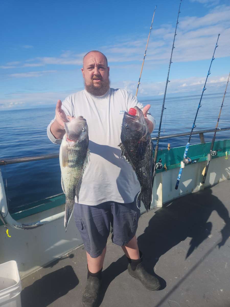 a man holding a fish in the water