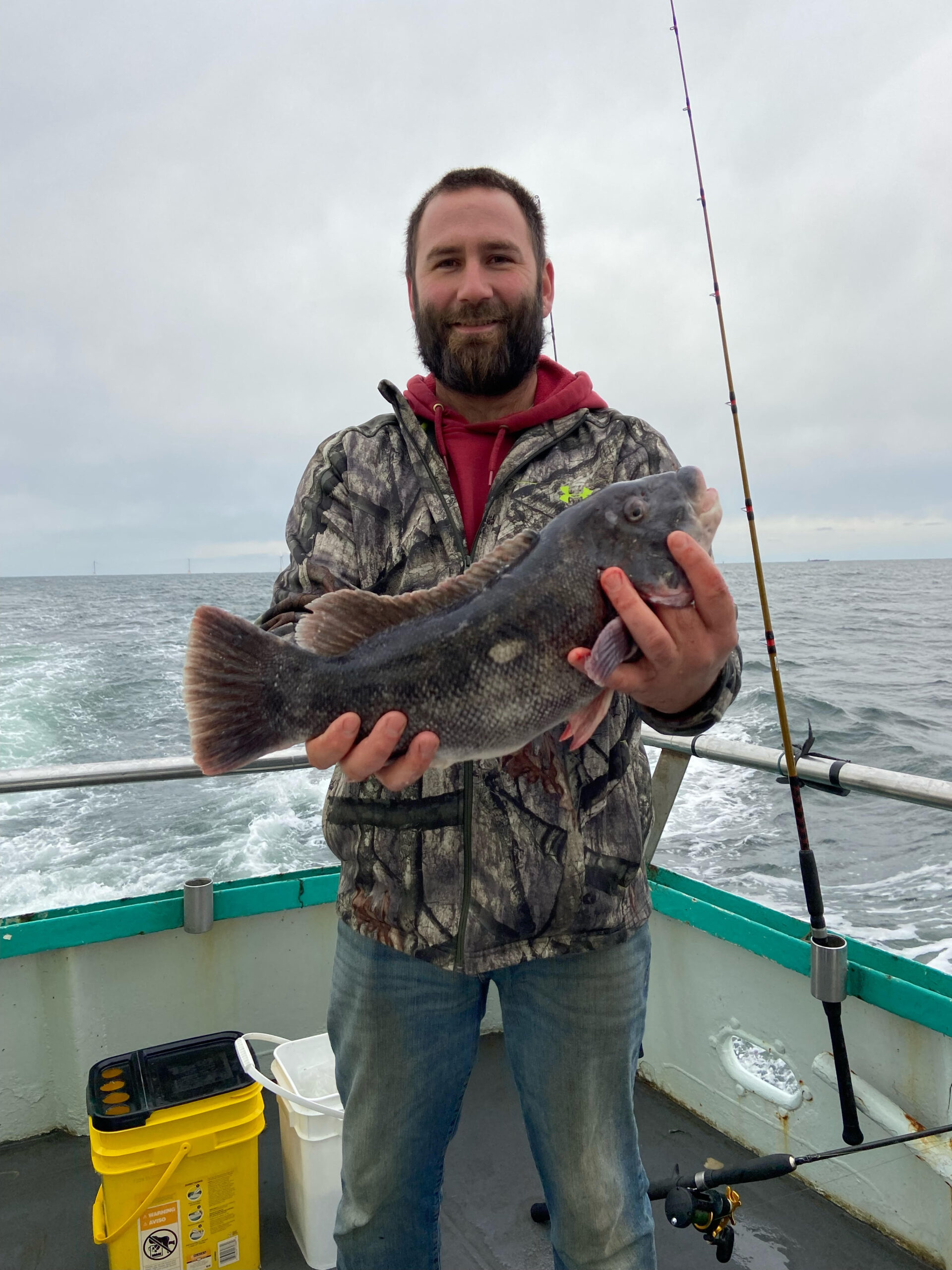 a man holding a fish in the water
