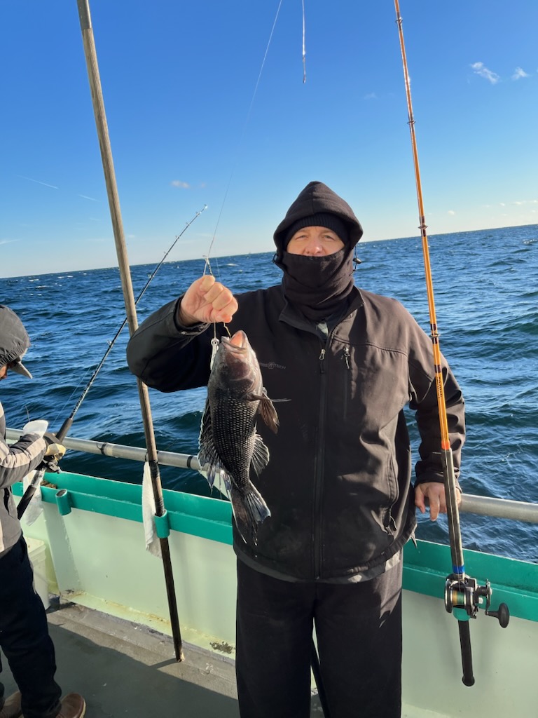 a man standing next to a body of water