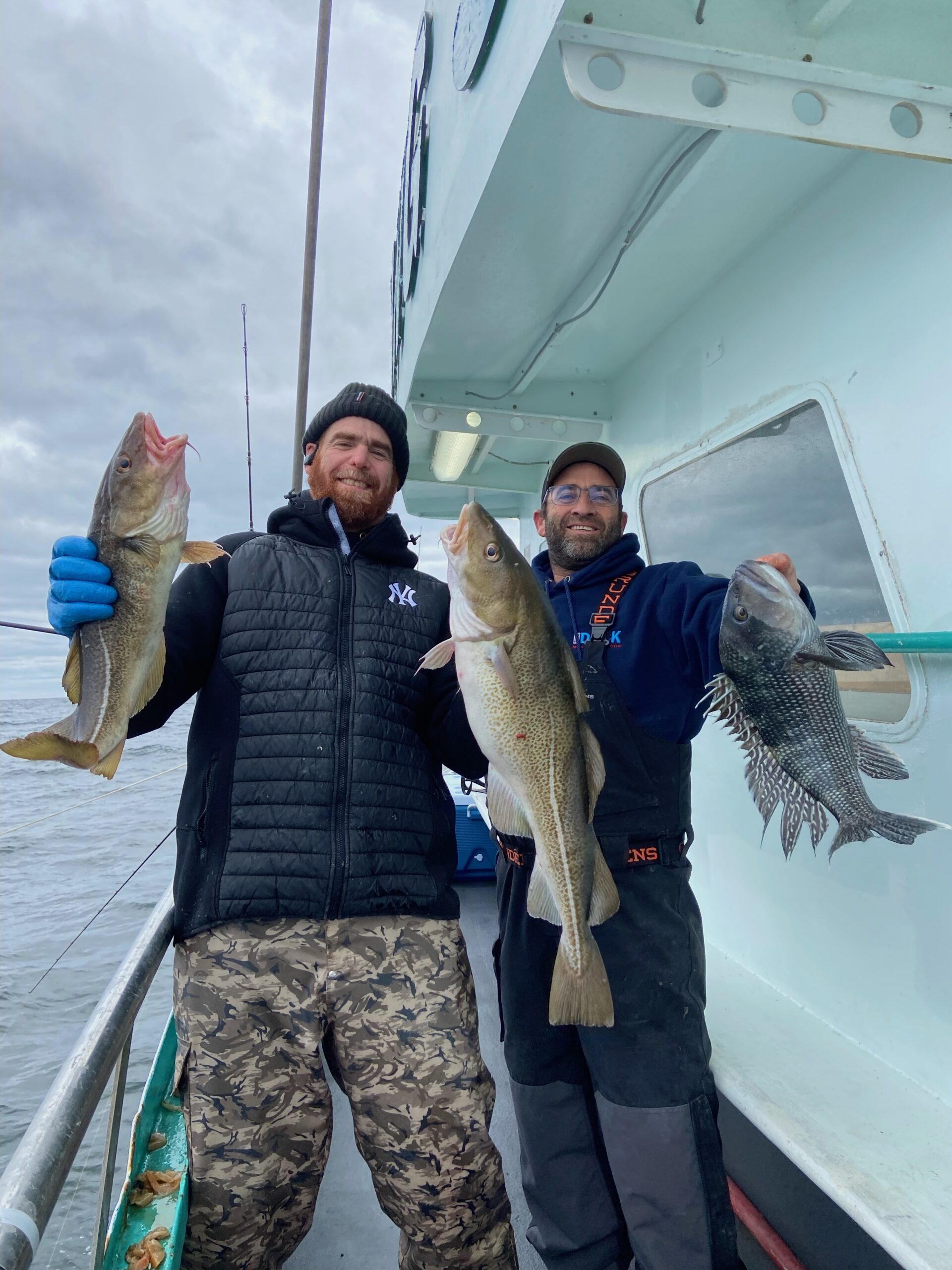 a person holding a fish posing for the camera