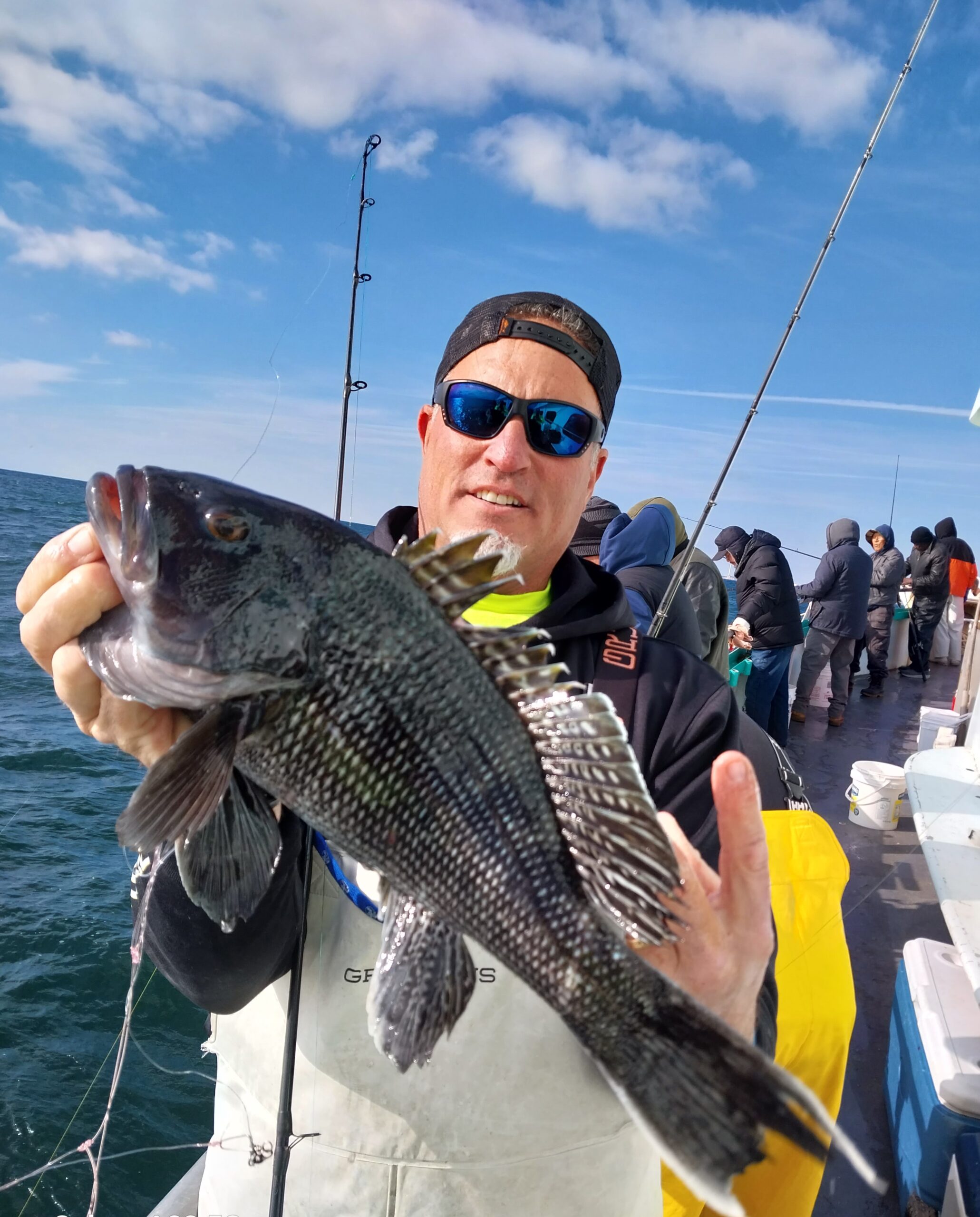 a man holding a fish in the water