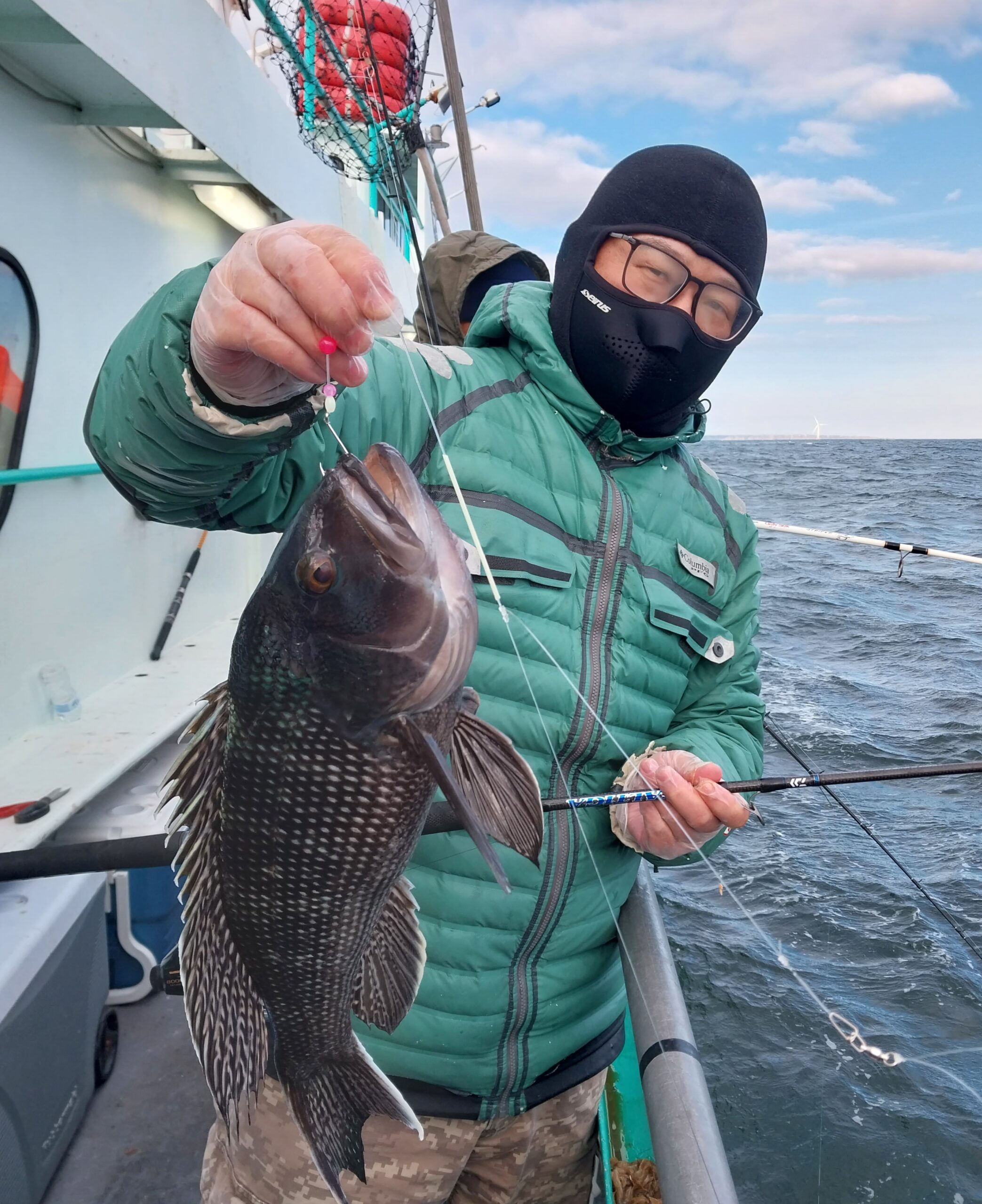 a person holding a fish in the water