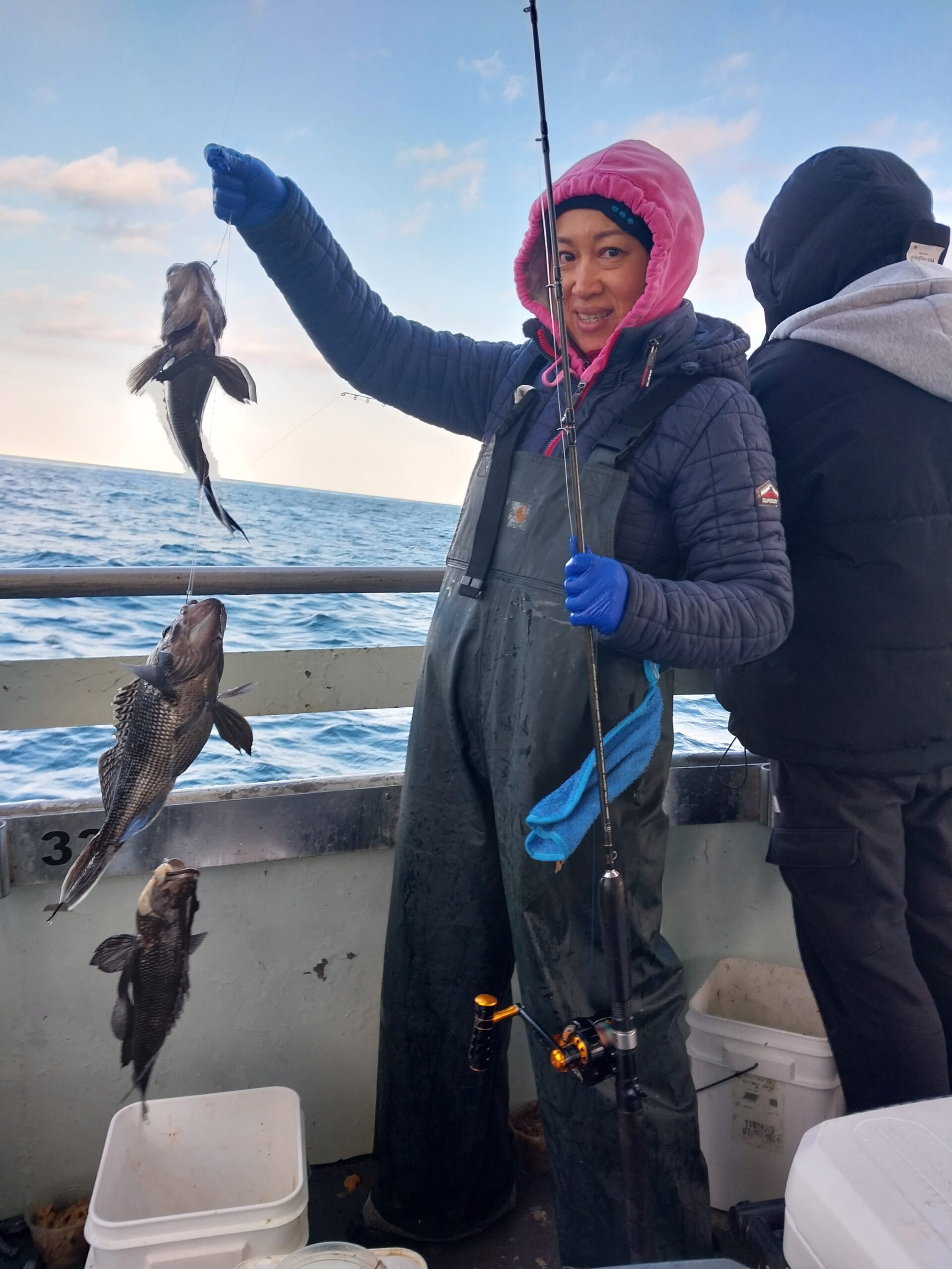 a man and a woman standing next to a body of water
