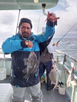 a person holding a fish in the water