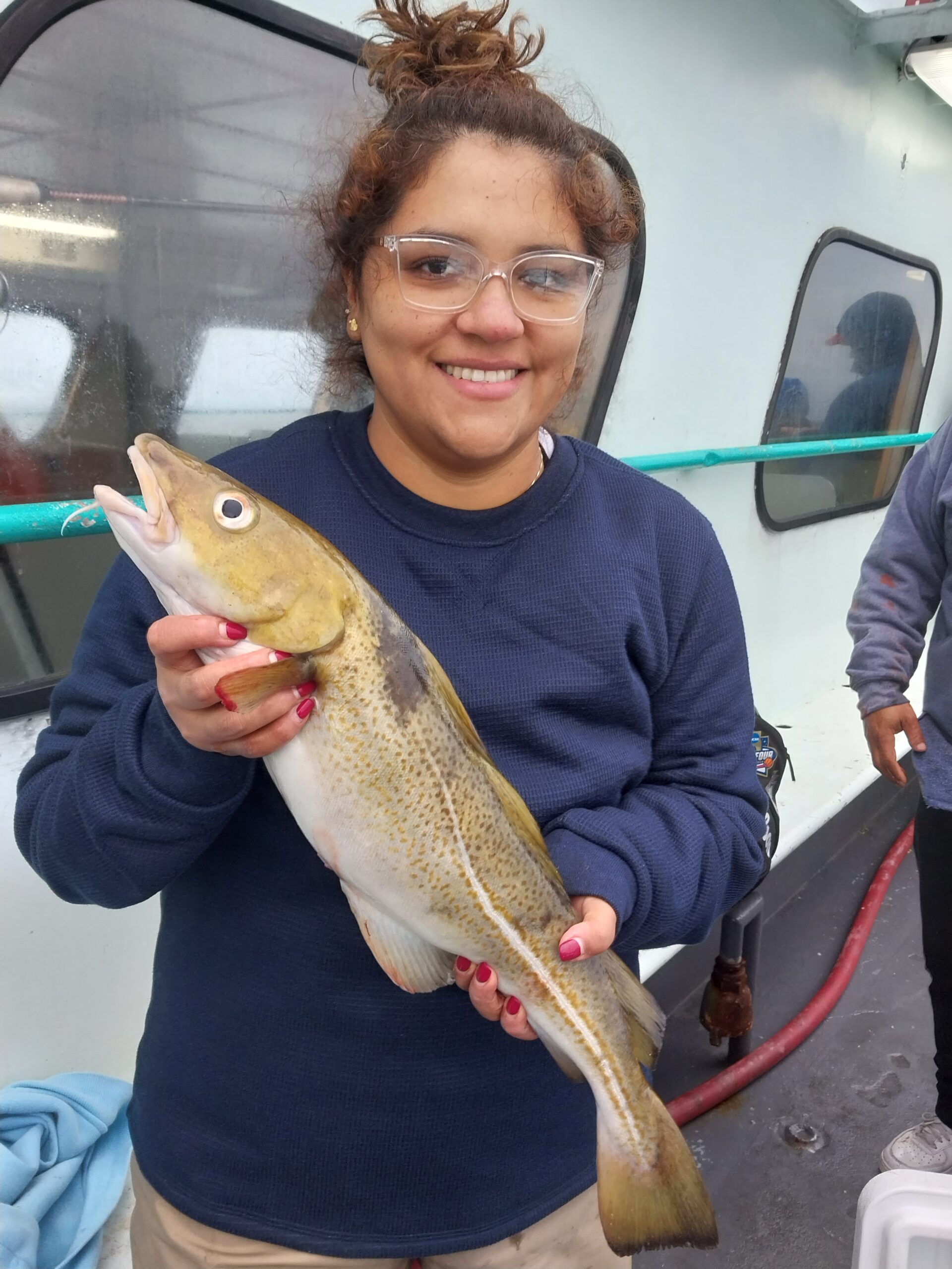 a woman holding a fish