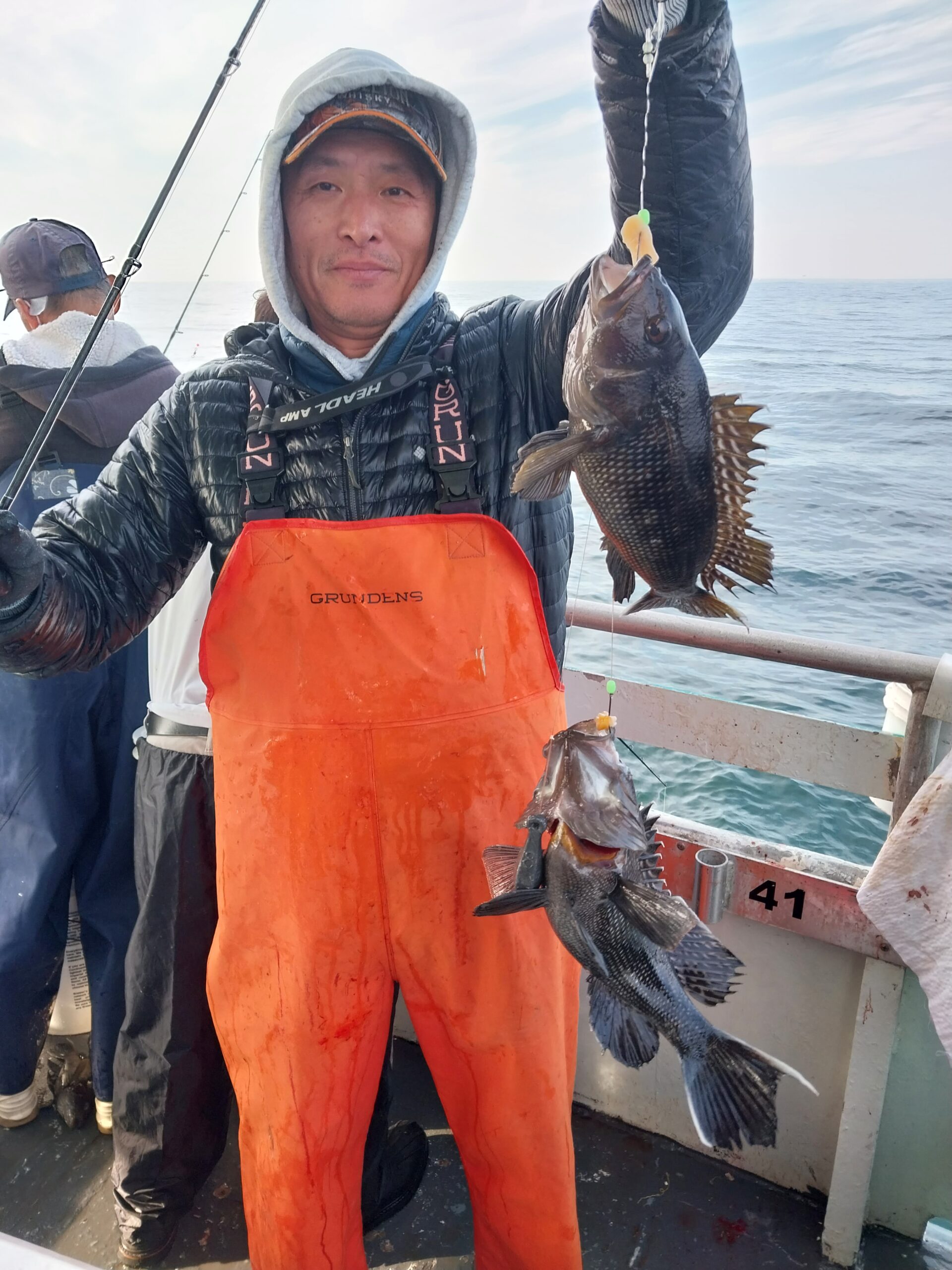 a man holding a fish in the water