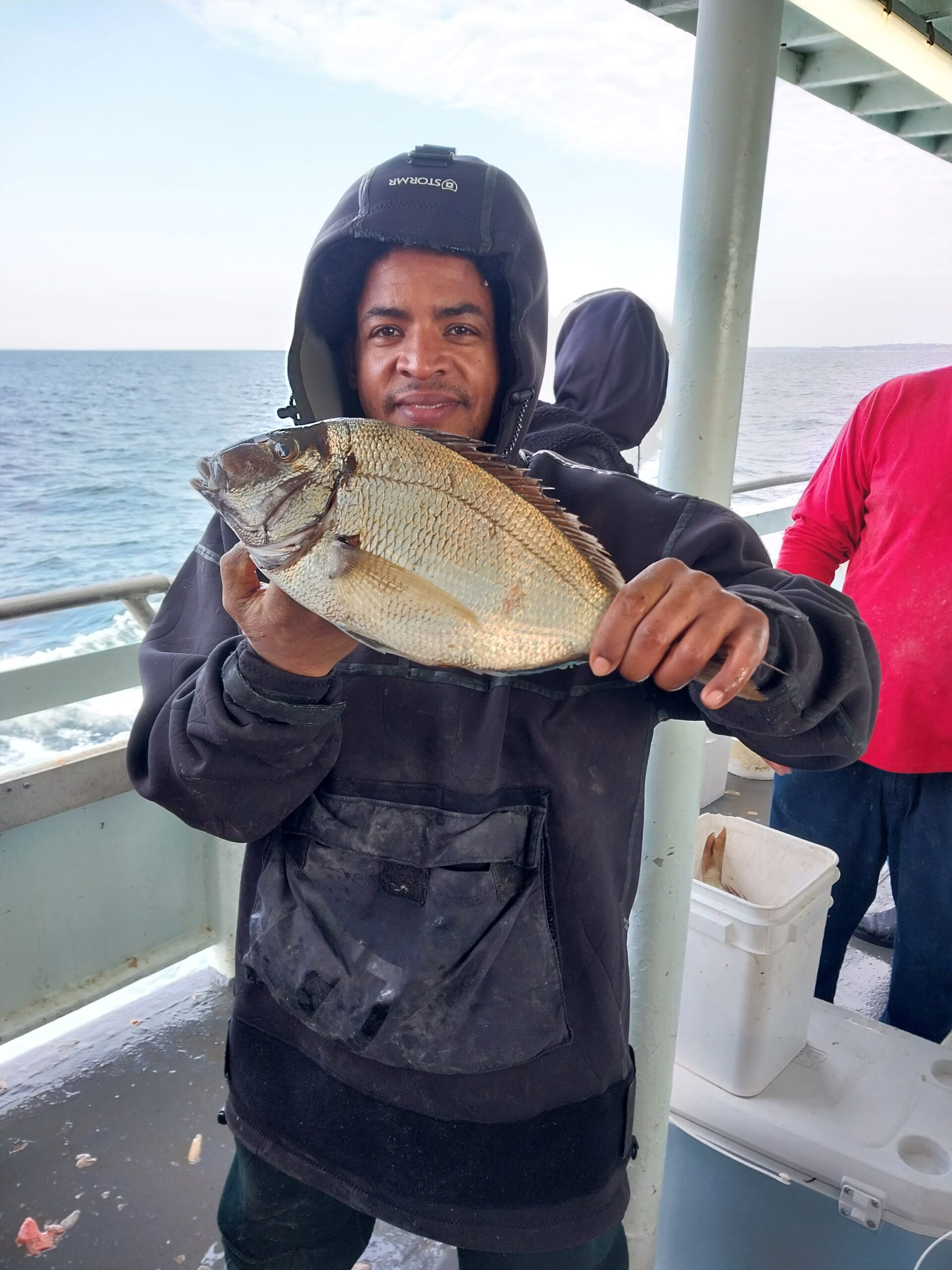 a person holding a fish in the water