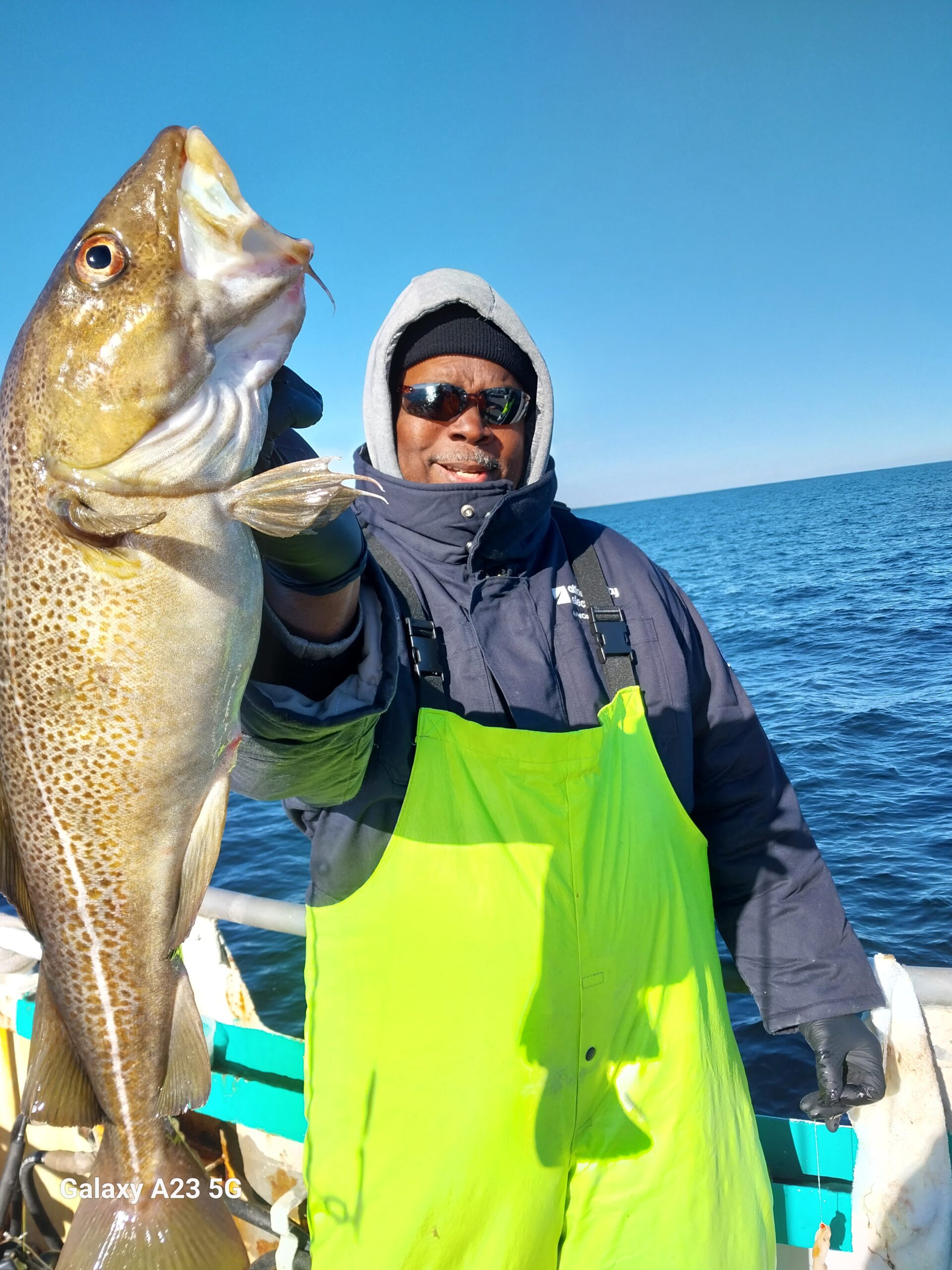 a person holding a fish in the water